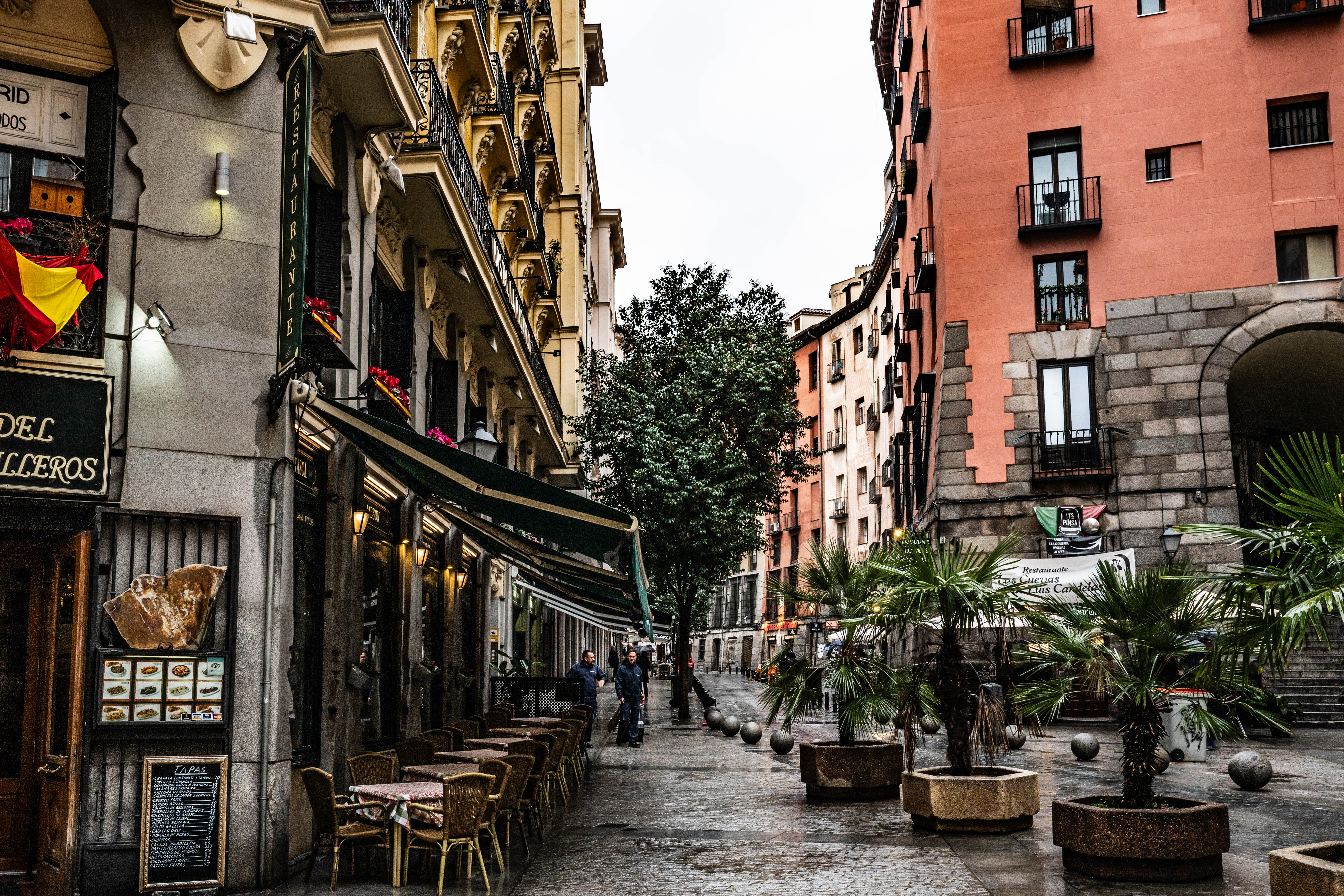 The street is relatively empty, with only a few people walking