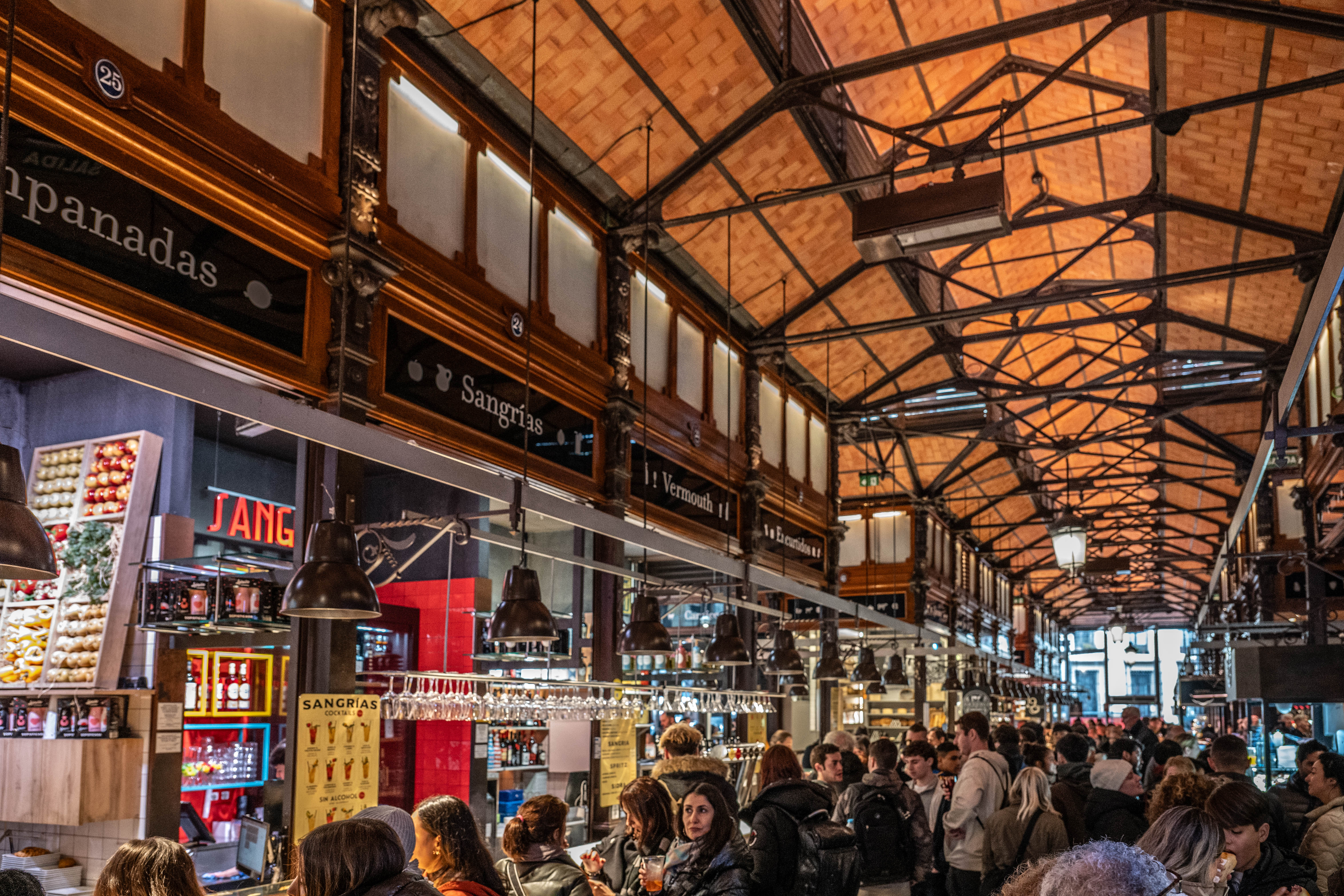 bustling indoor market with a high, intricately designed ceiling