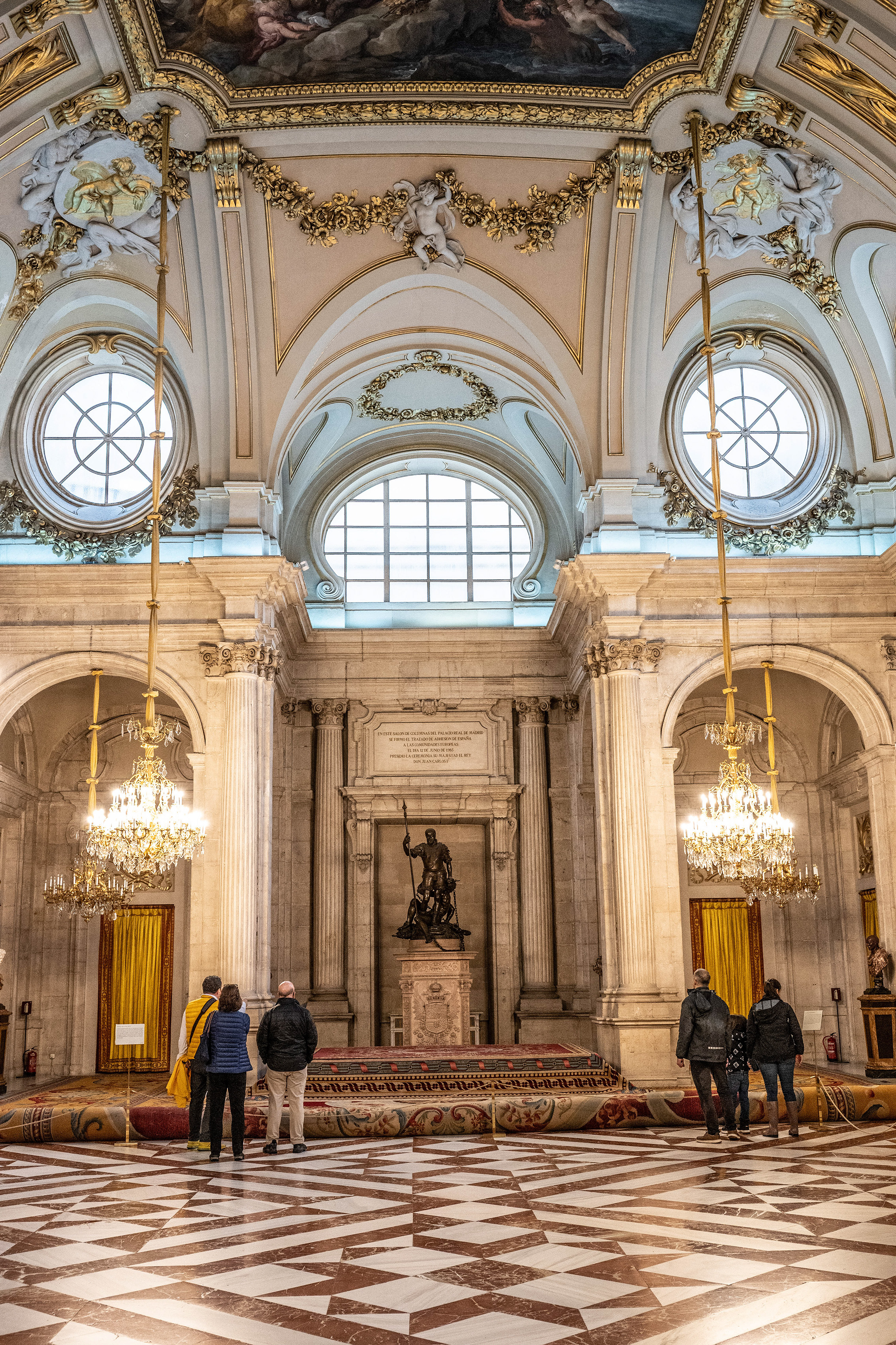 The room features high ceilings adorned with intricate frescoes and sculptures