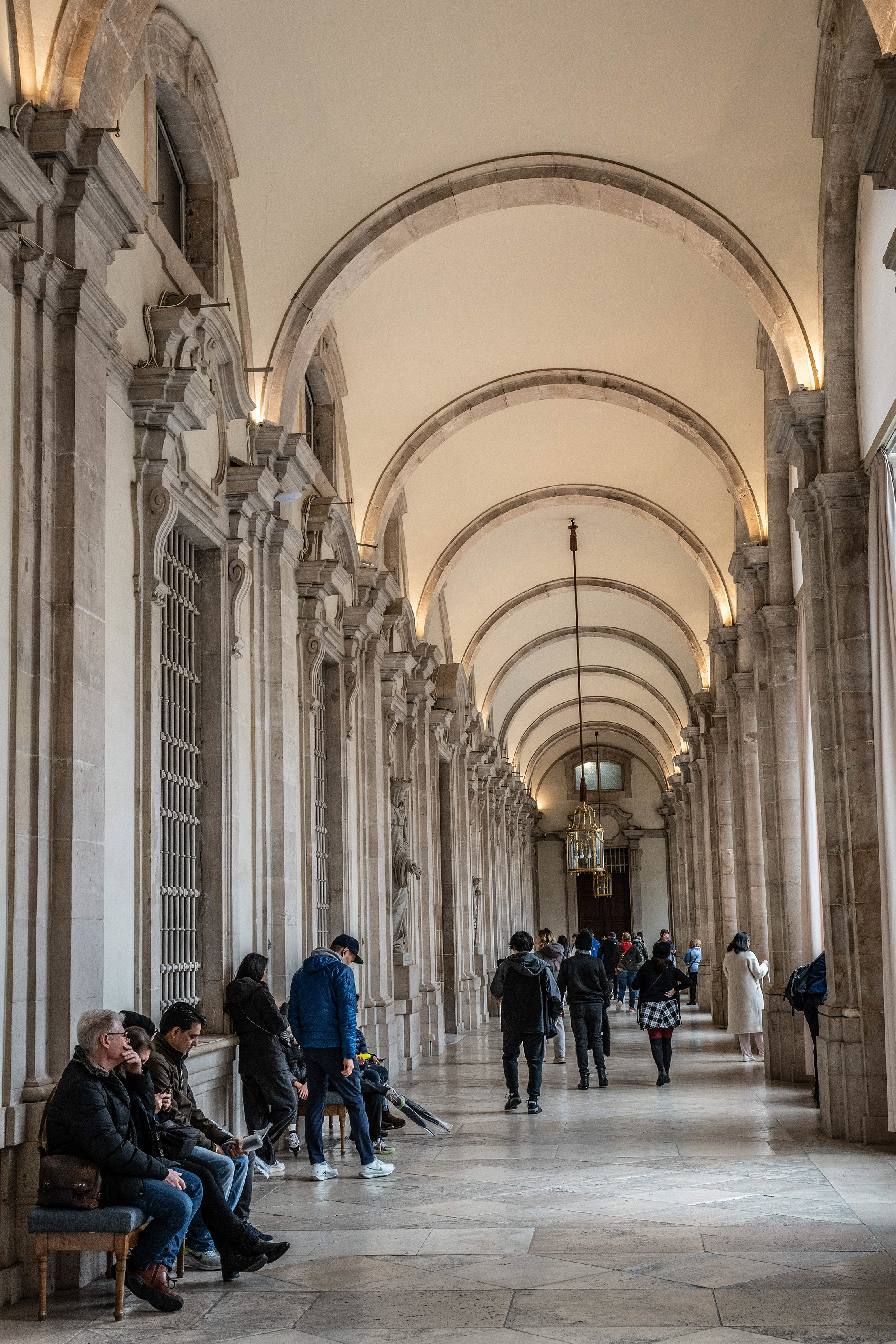 a corridor with a series of arches and columns