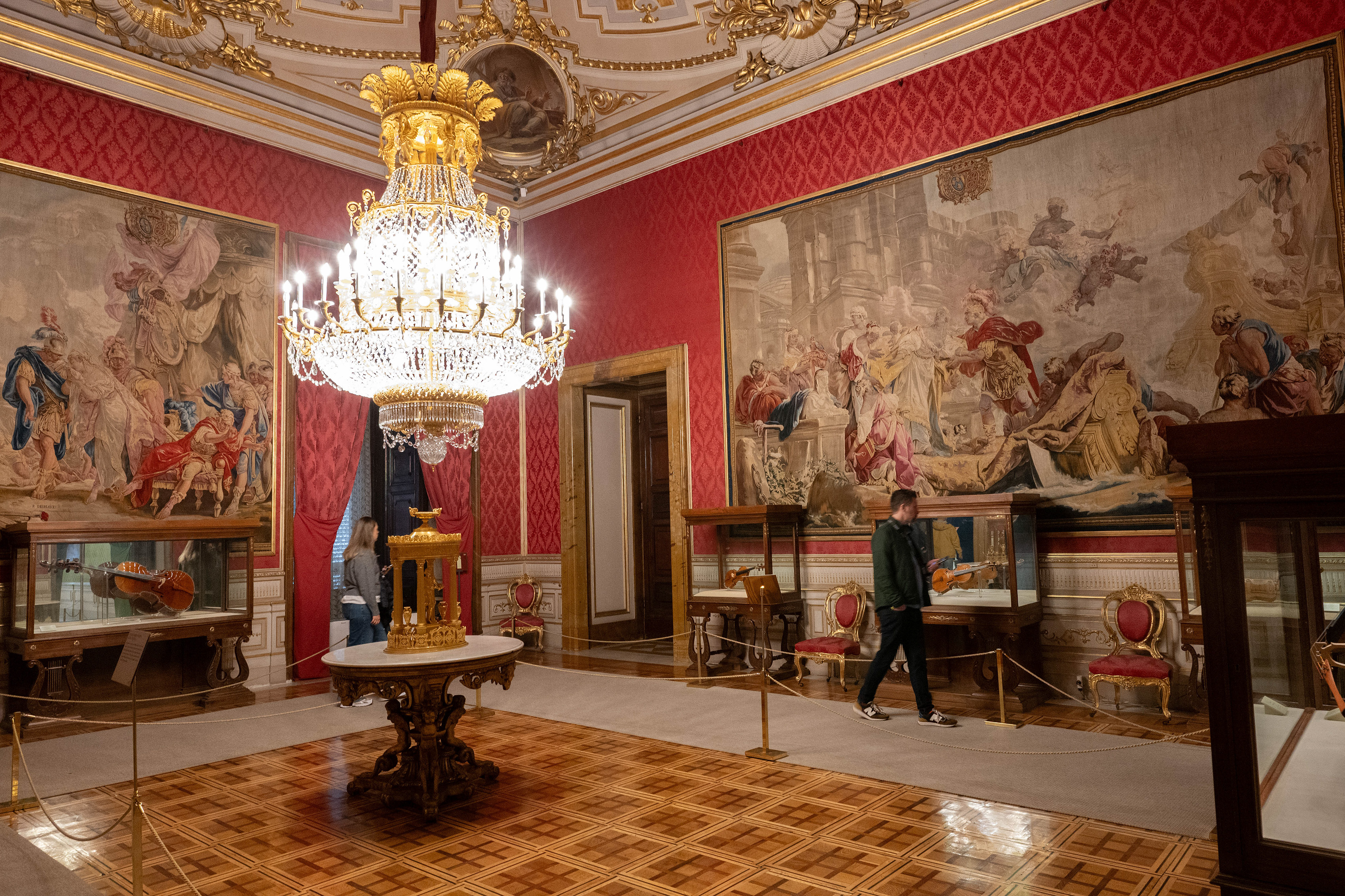 ornately decorated room with rich red walls and intricate gold accents