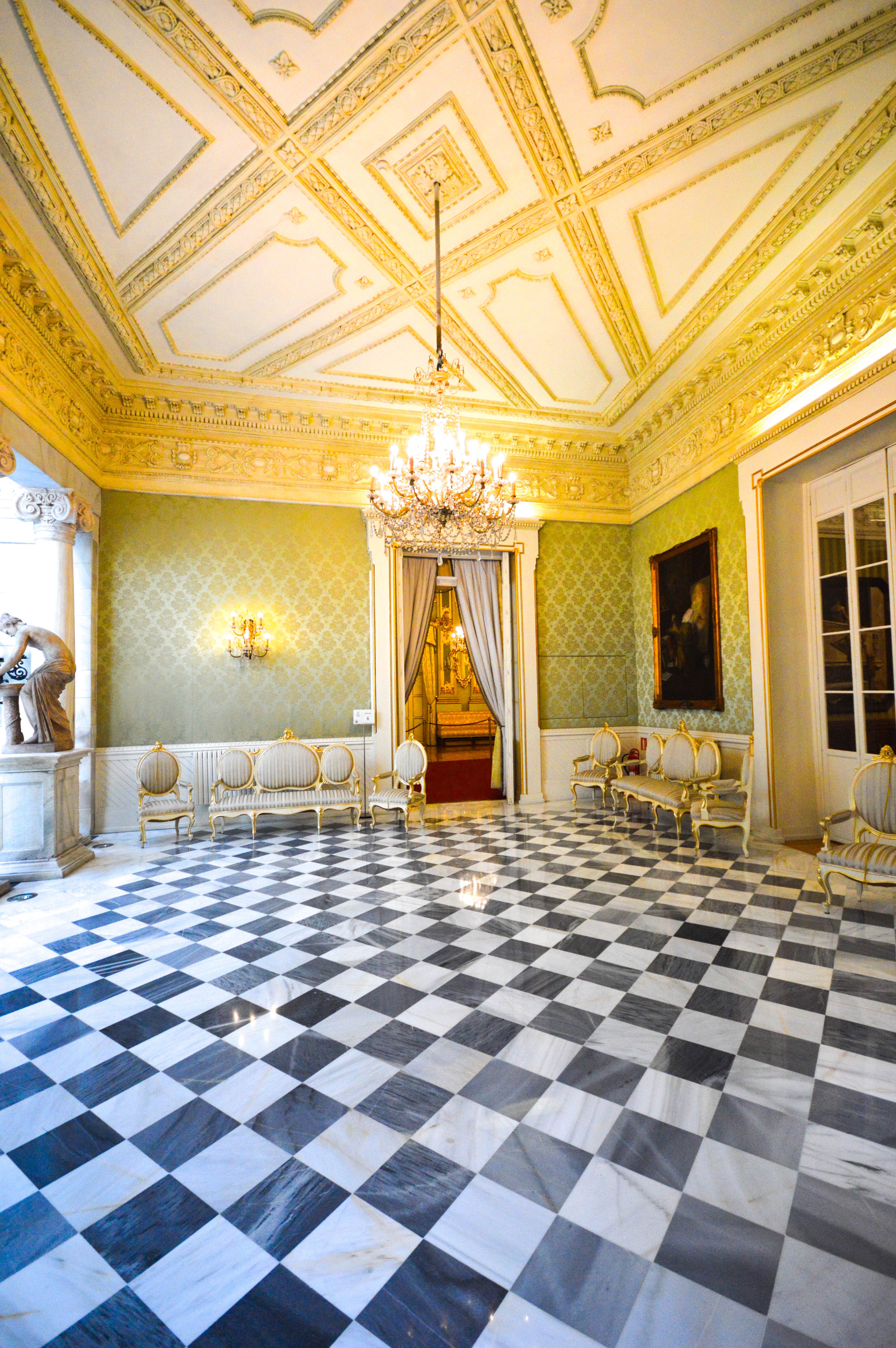 a checkered marble floor, ornate gold and white walls