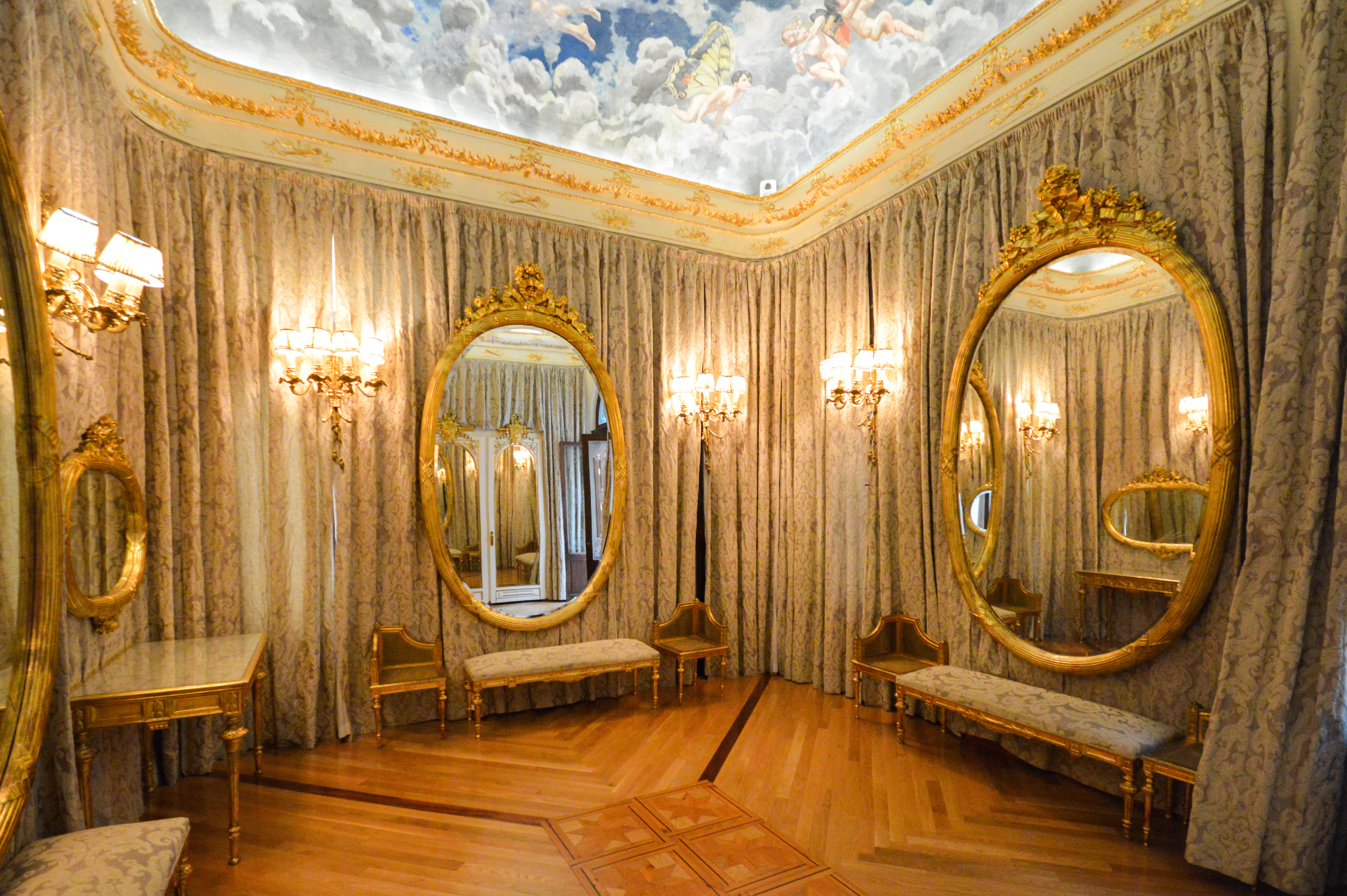 an opulently decorated room with ornate mirrors