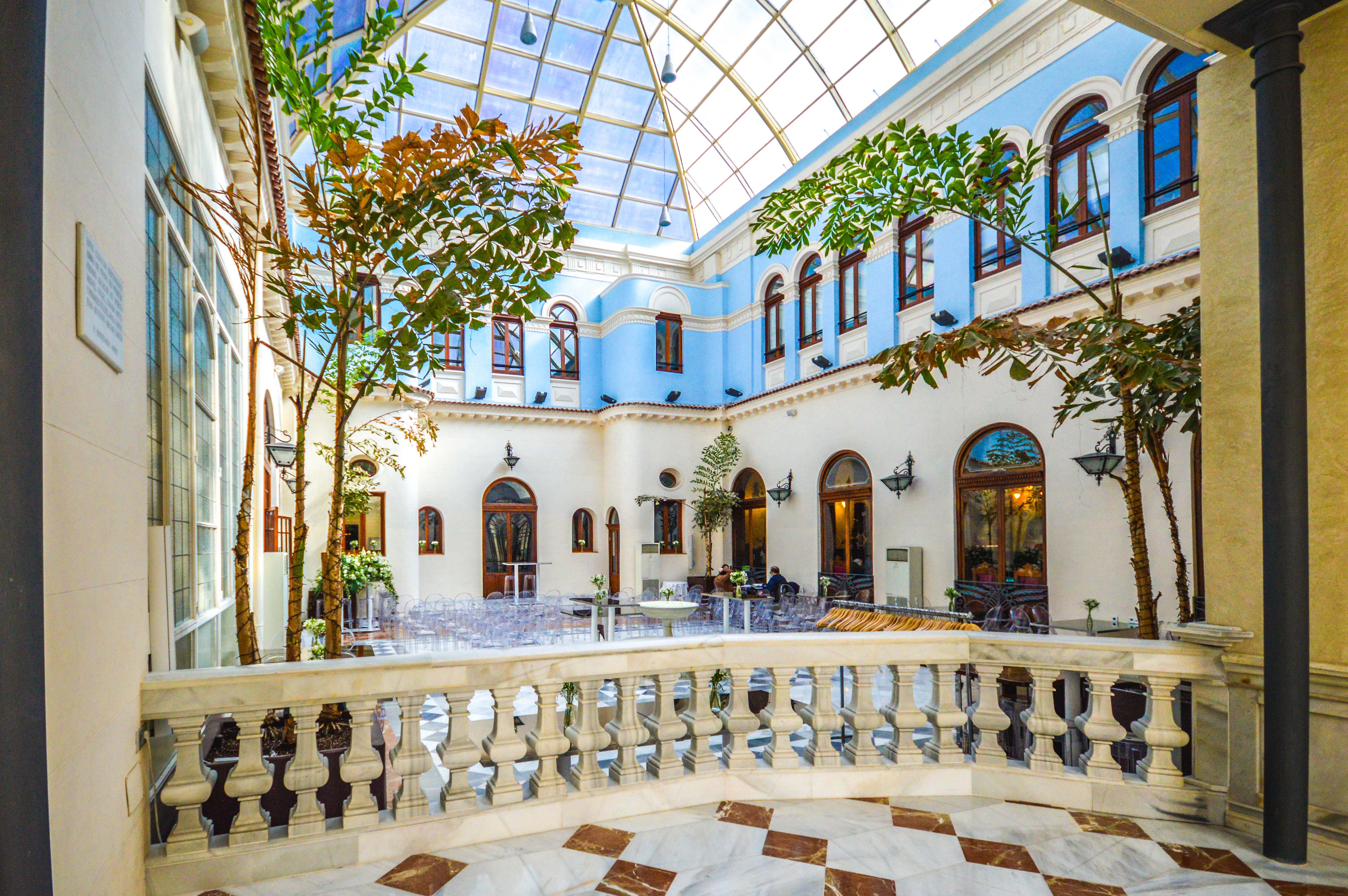 indoor courtyard with a glass ceiling, allowing natural light to illuminate the space