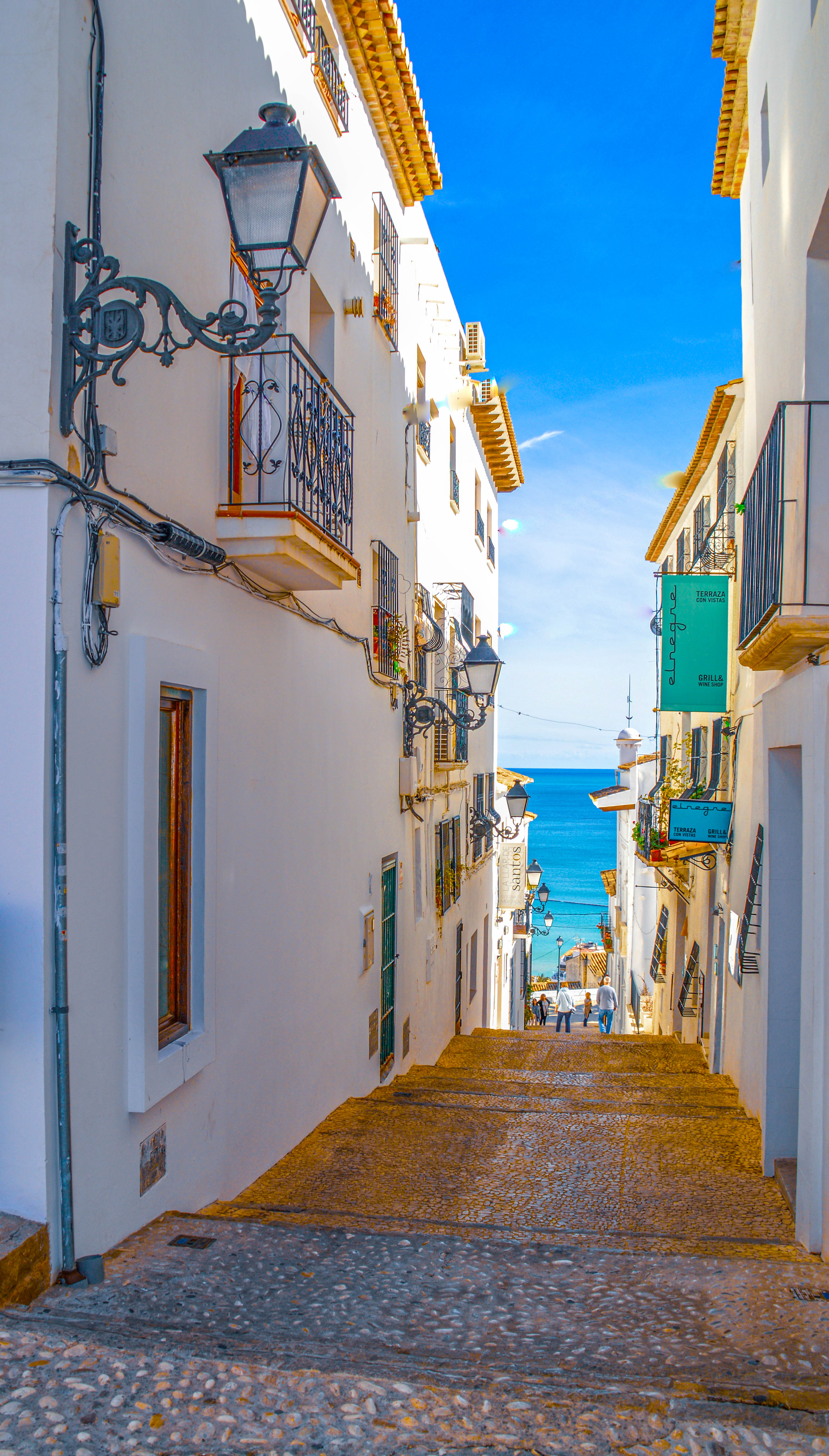 white buildings with wooden balconies and wrought iron railings