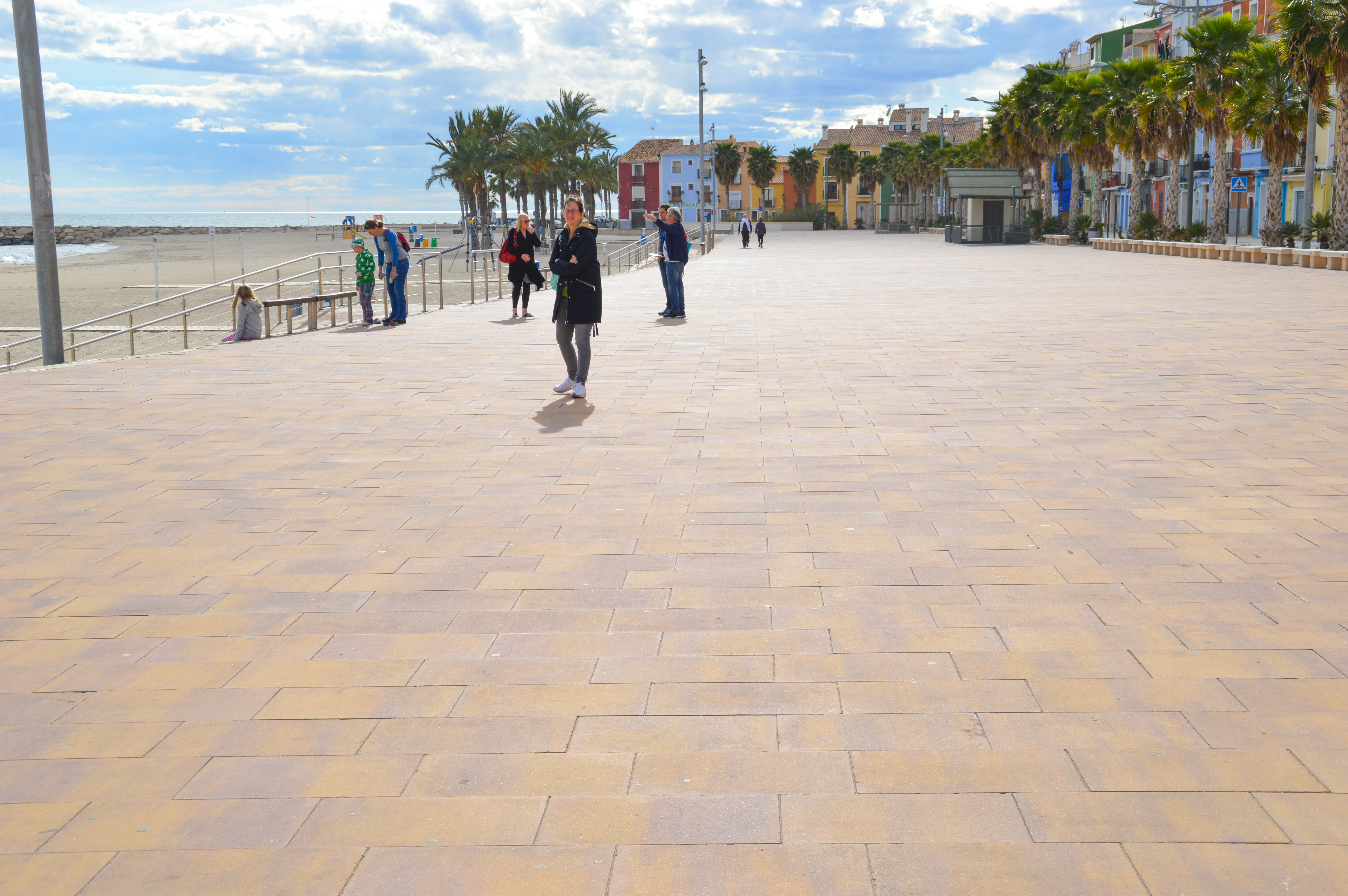 a scenic seaside promenade with a few people walking and enjoying the view