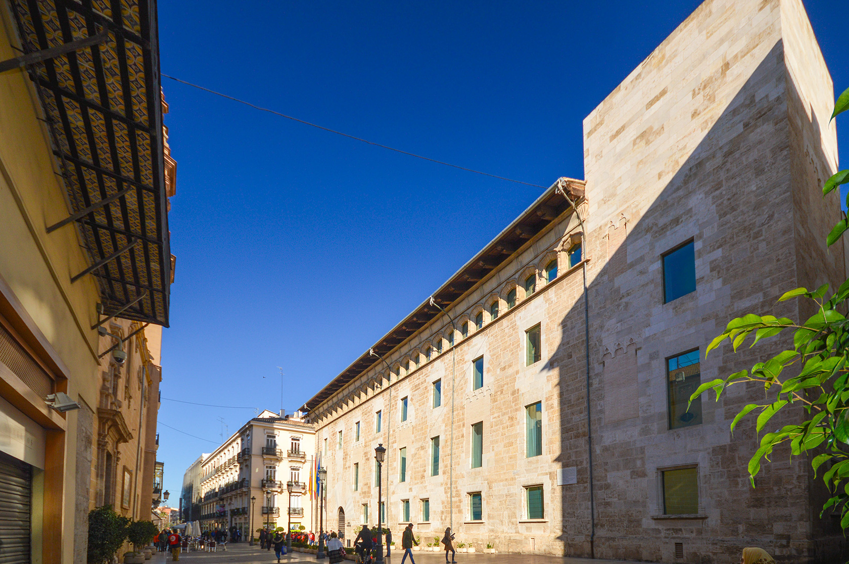 The street is lined with people walking