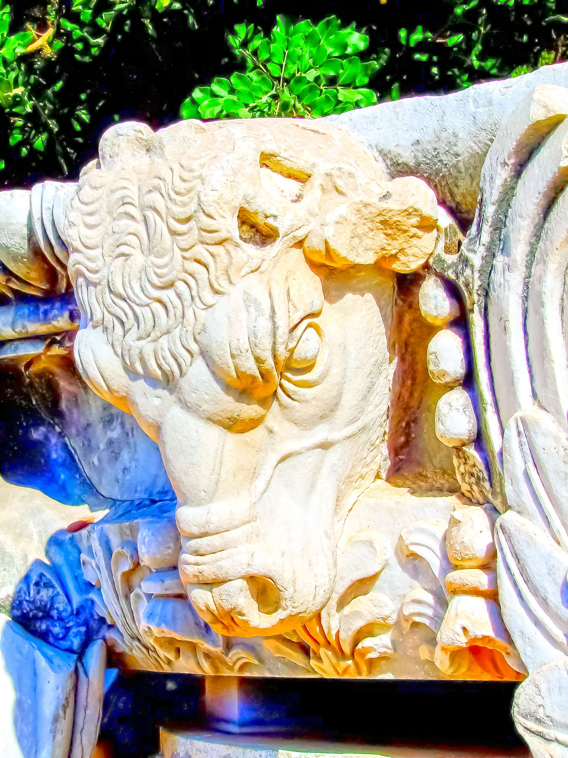 ancient stone sculpture of a bull's head