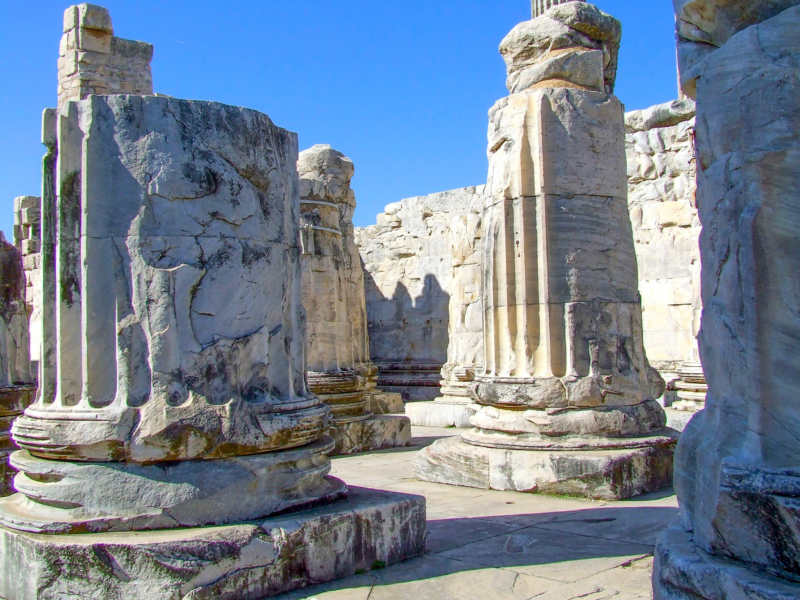 large, weathered stone columns and remnants of walls