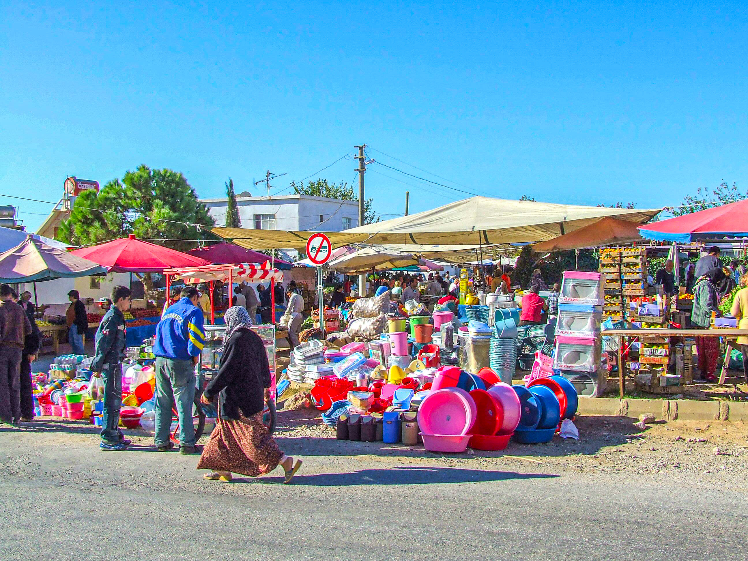 a bustling outdoor market with various stalls under large canopies