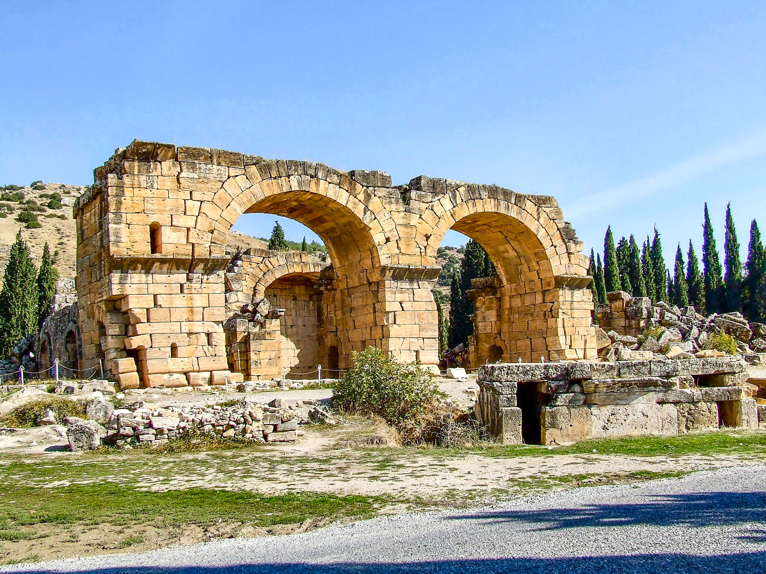 The image depicts the ancient ruins of an aqueduct