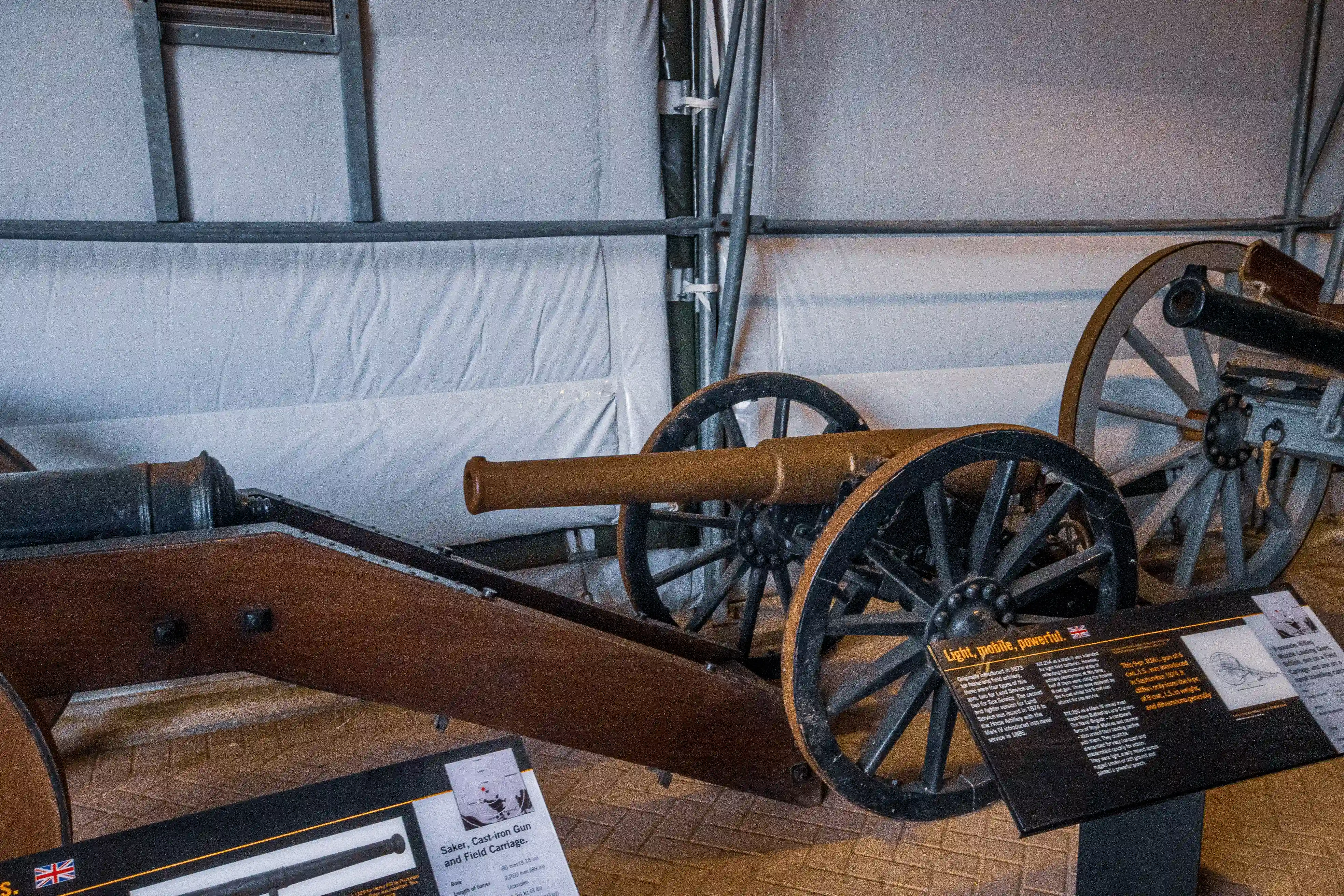 The document describes a historical artillery piece, specifically a Saker cast-iron gun with a field carriage. Key details include its origin in England around 1543, its weight of 2,200 pounds, and its role as a significant military weapon. The gun is noted for its light, portable, and powerful characteristics, reflecting advancements in artillery technology during the Tudor period.