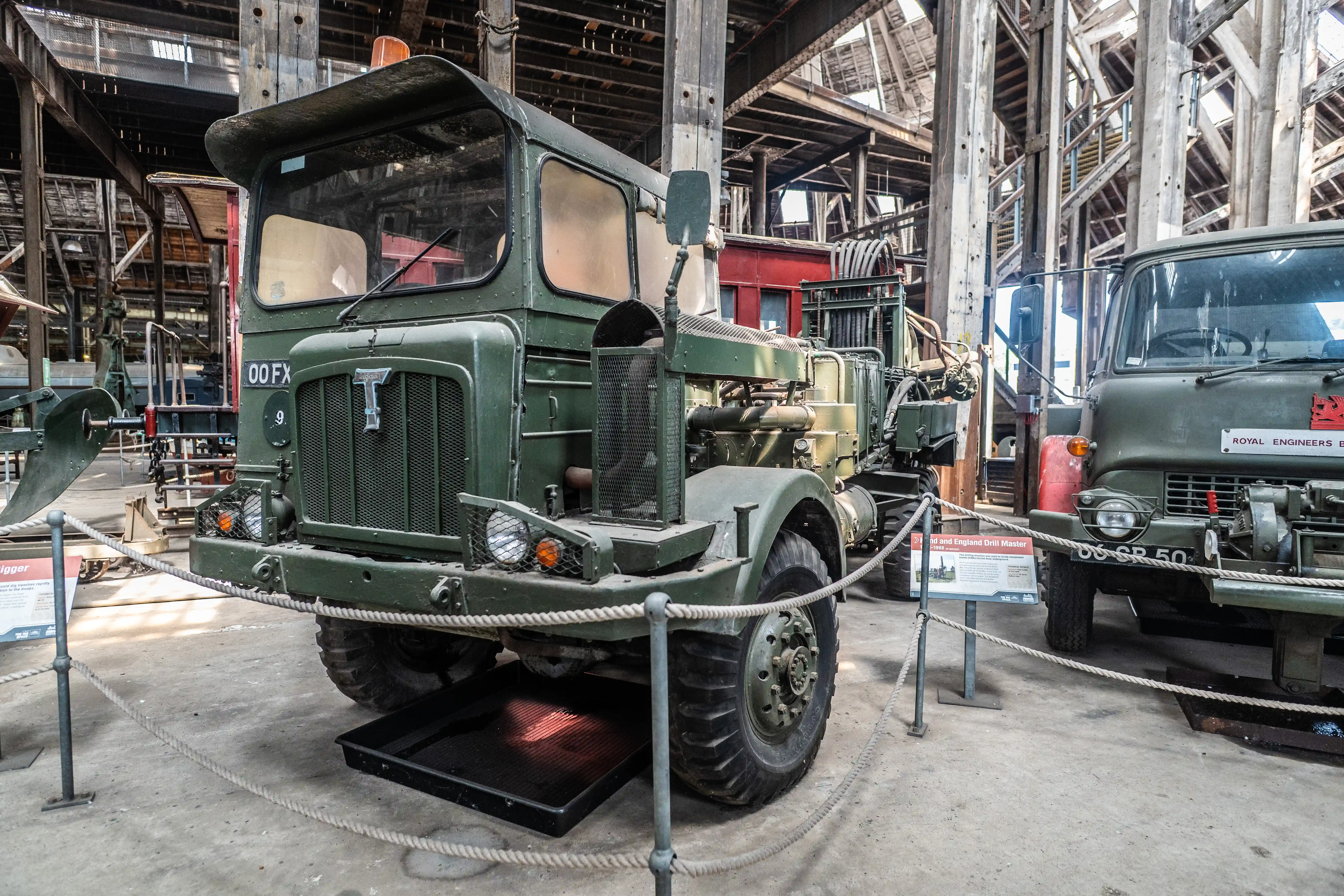 A close-up shot of a green vintage military truck with a large grille and 