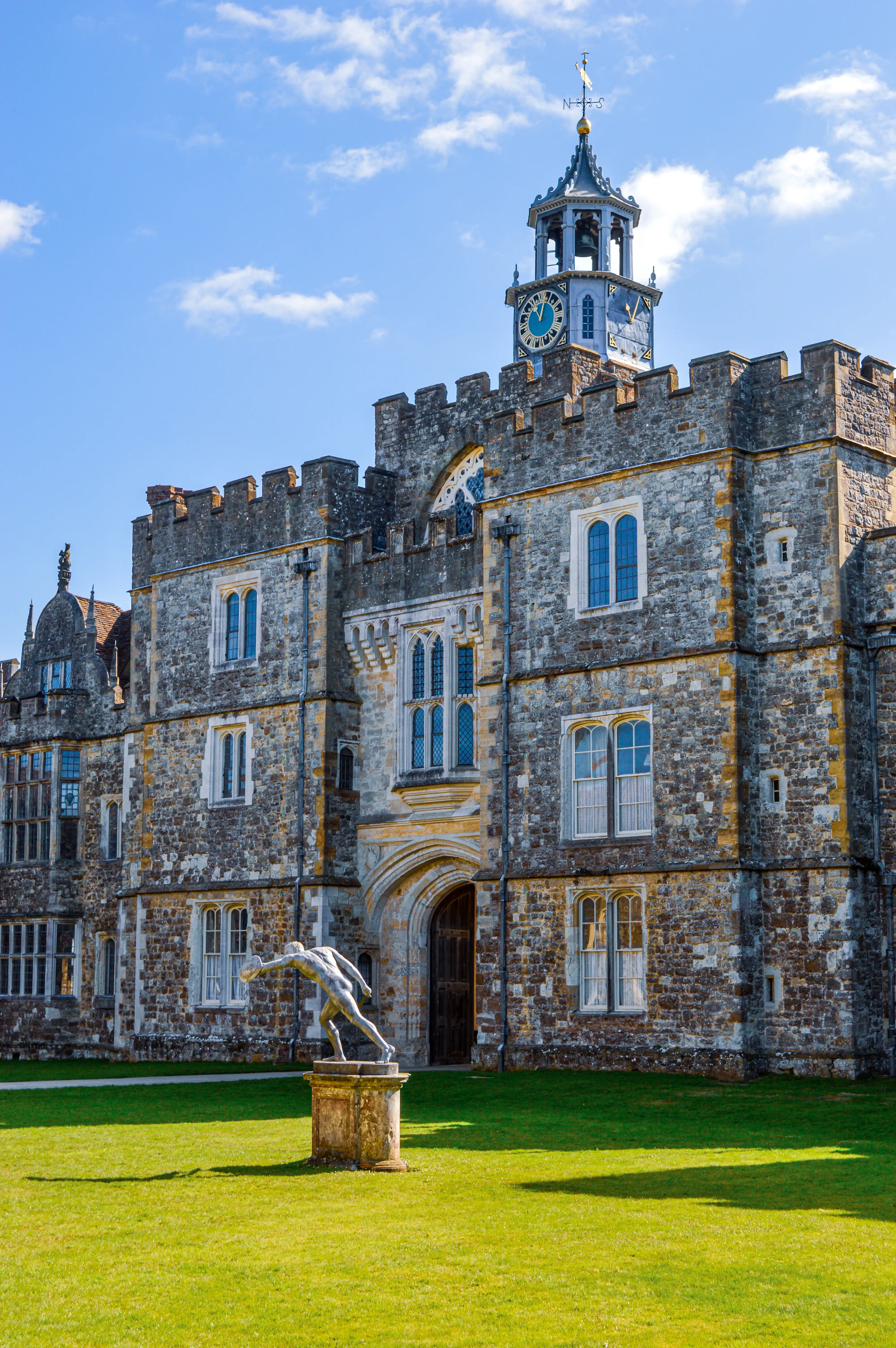 Manor House with Clock Tower and Garden Statue
