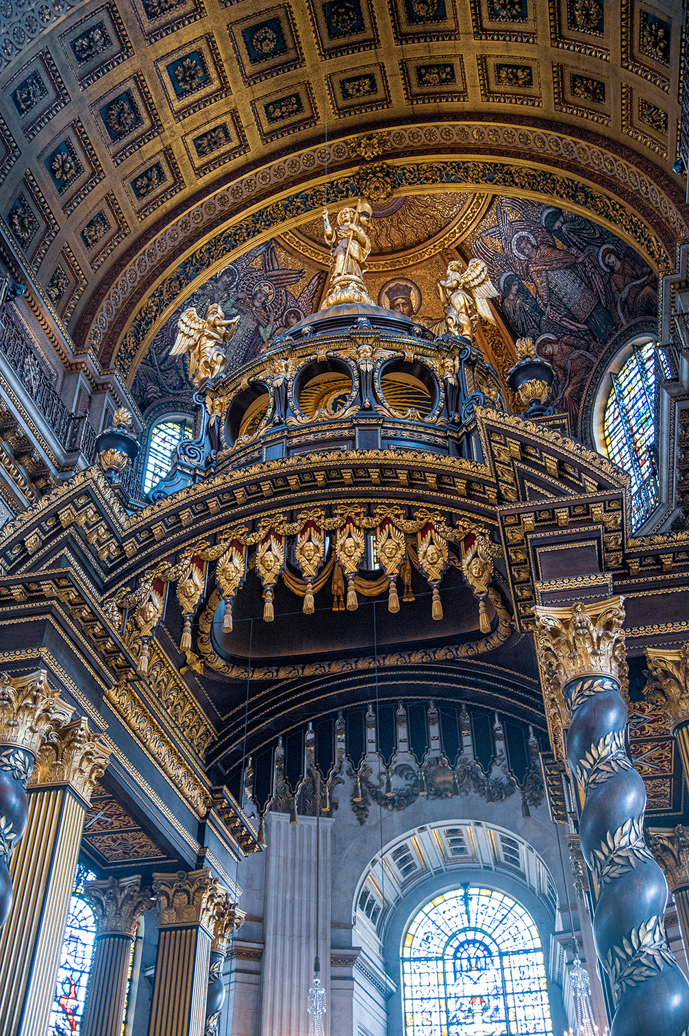 The image showcases the intricate and ornate interior of a grand cathedral, featuring detailed gold and dark color schemes, elaborate carvings, statues, and stained glass windows.