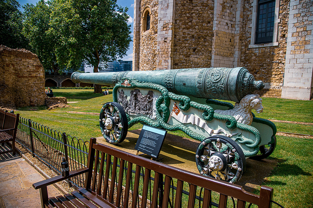 Cannons: In the foreground and center of the image is a large, ornate cannon mounted on a wheeled carriage.