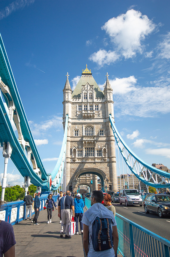  Tourists Stroll Across Iconic Tower Bridge on a Sunny Day