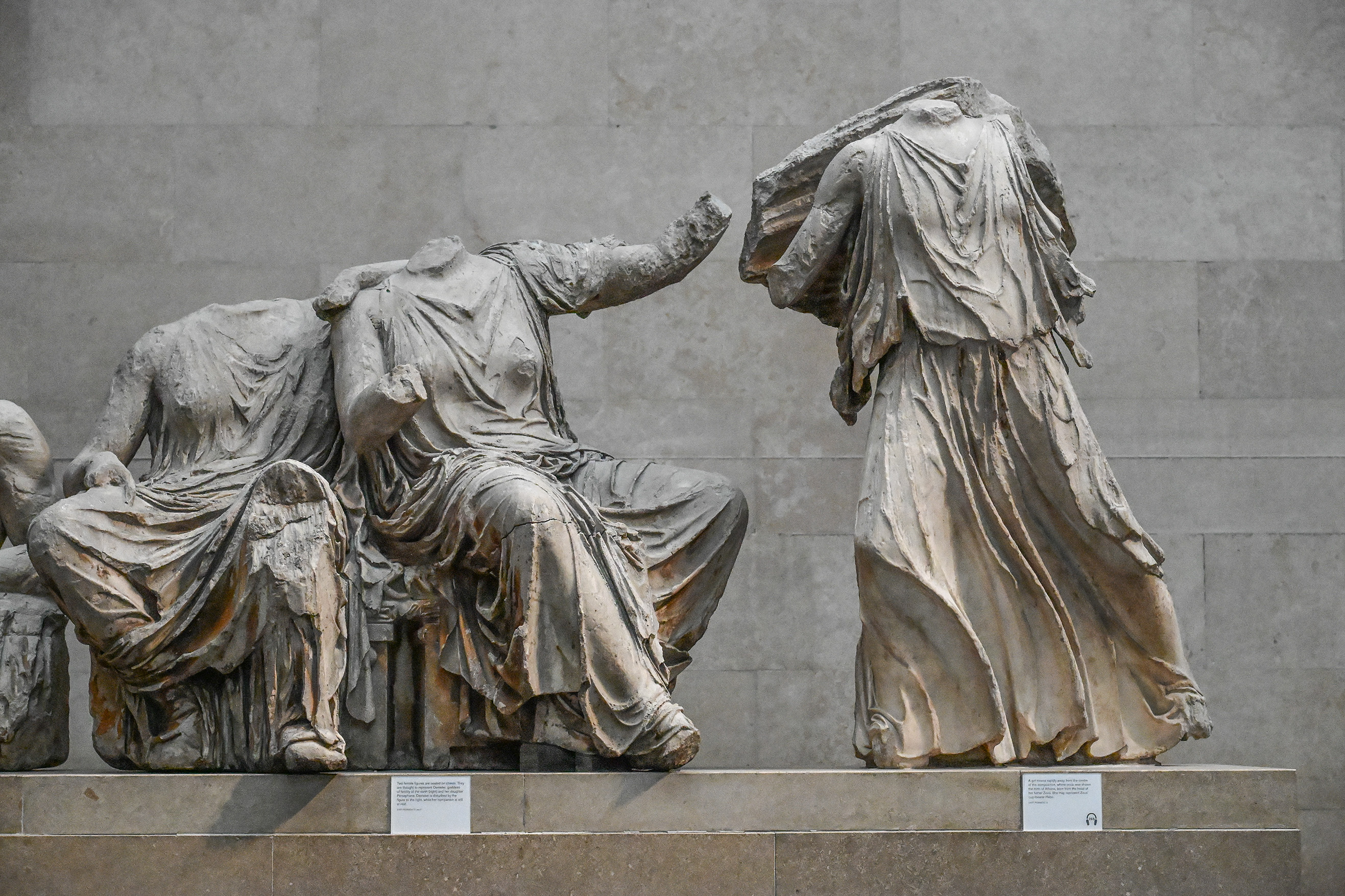 The document describes a marble sculpture from the Parthenon, created around 442-438 BC by an unknown sculptor. It depicts three figures: Artemis, goddess of the hunt; a seated goddess, possibly Demeter or Hestia; and a third figure, likely Iris or another goddess. The sculpture is part of the 'Pediment of the Parthenon' and is currently housed in the British Museum. The figures are shown in a dramatic scene, with Artemis gesturing towards a bull, and the seated goddess in a contemplative pose. The sculpture is noted for its intricate details and the flowing drapery of the figures' garments.