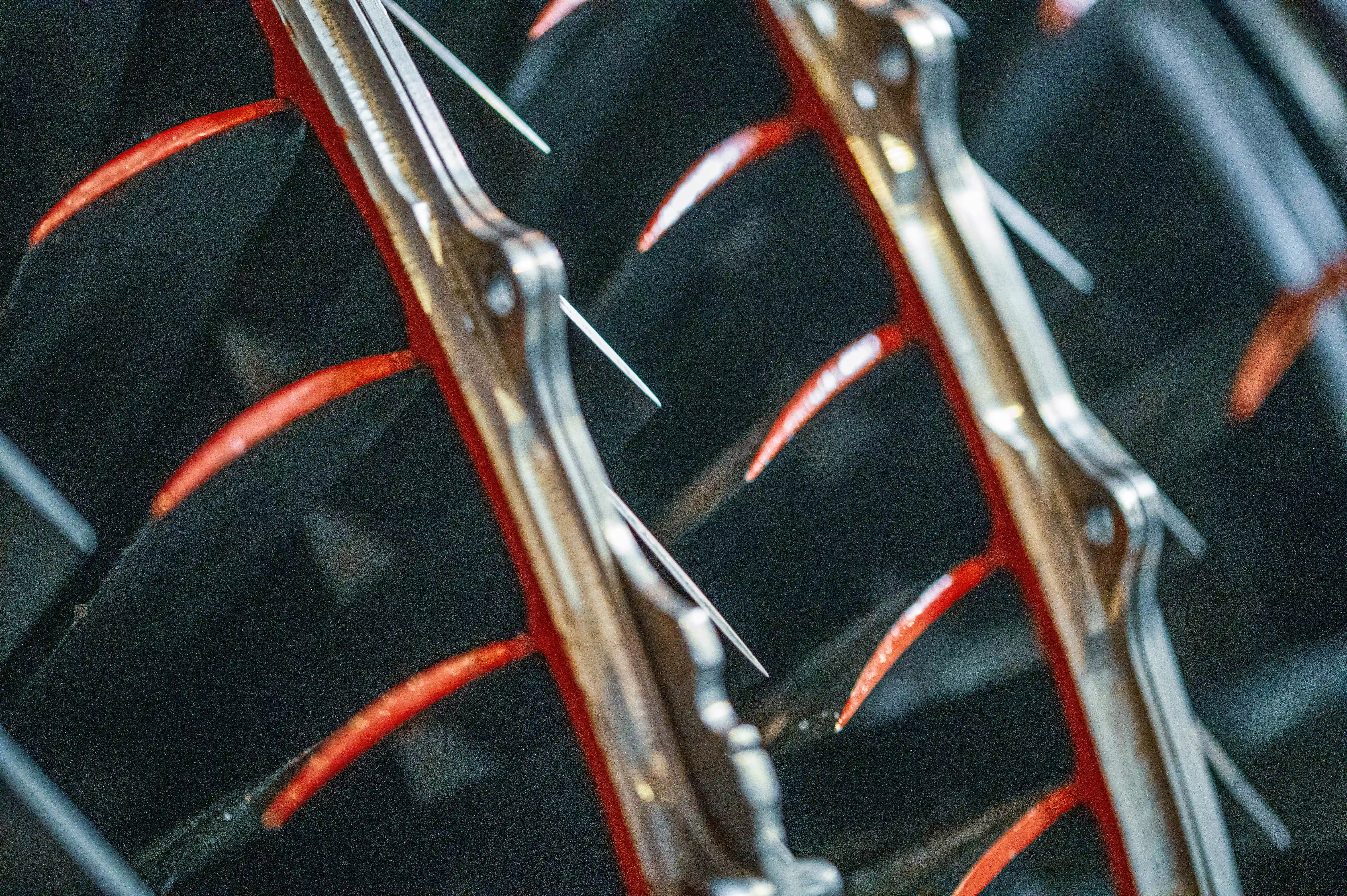 A macro photograph shows the inner workings of a jet engine, focusing on the metallic blades with red accents.