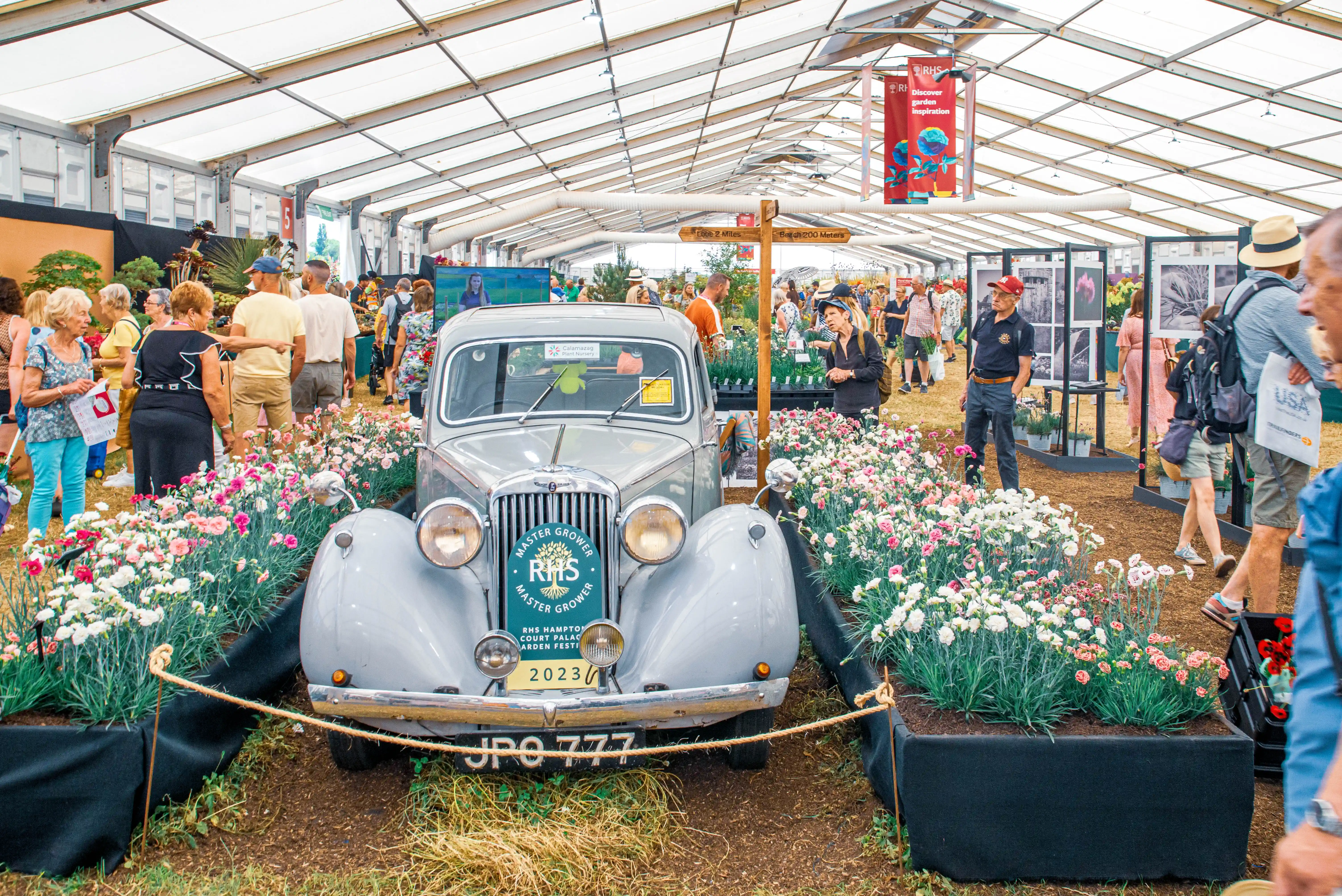 A vintage grey car, adorned with a 