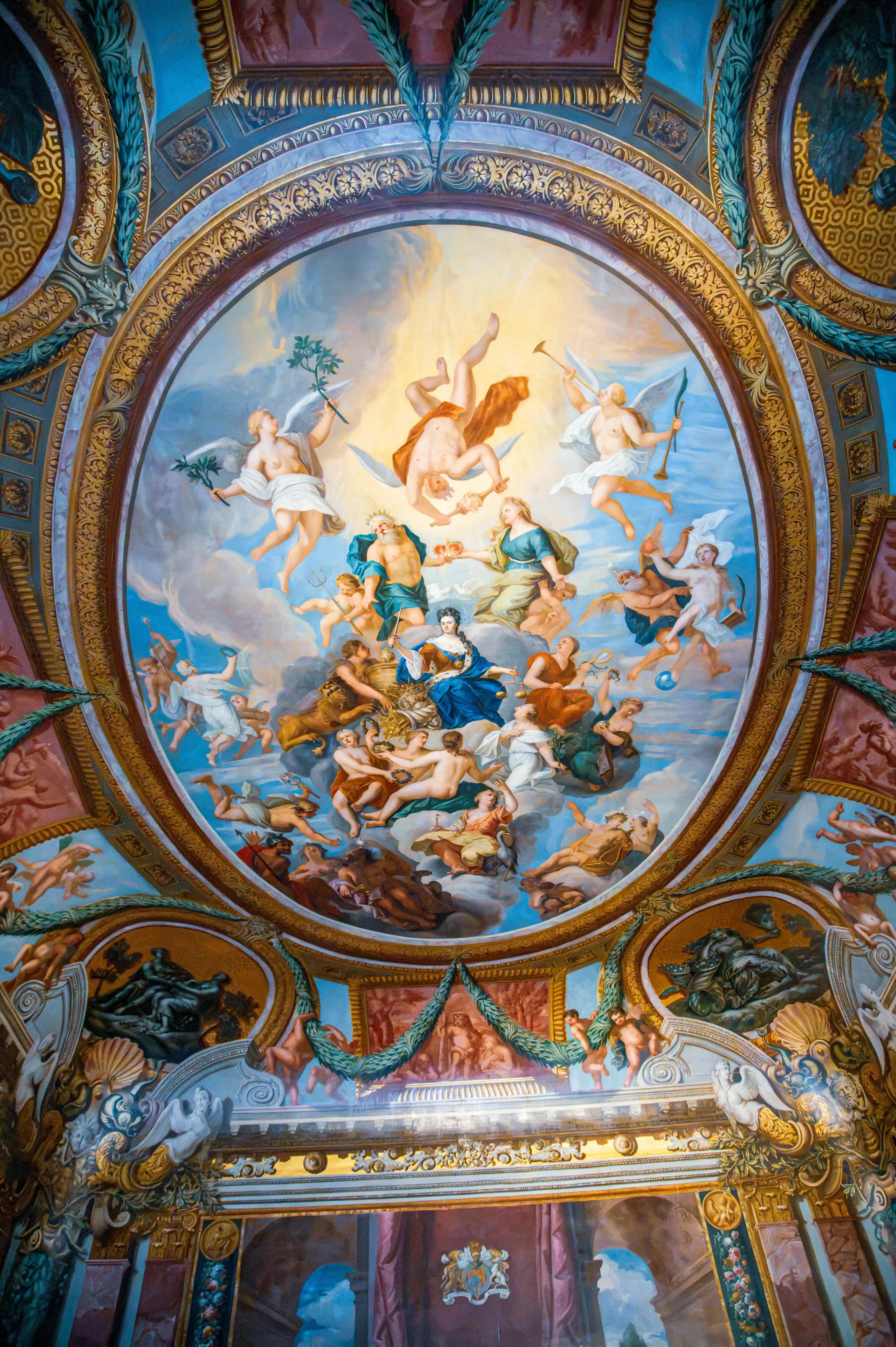 Ornate ceiling fresco with ascending classical figures framed by gilded mouldings and sculpted architectural decoration.