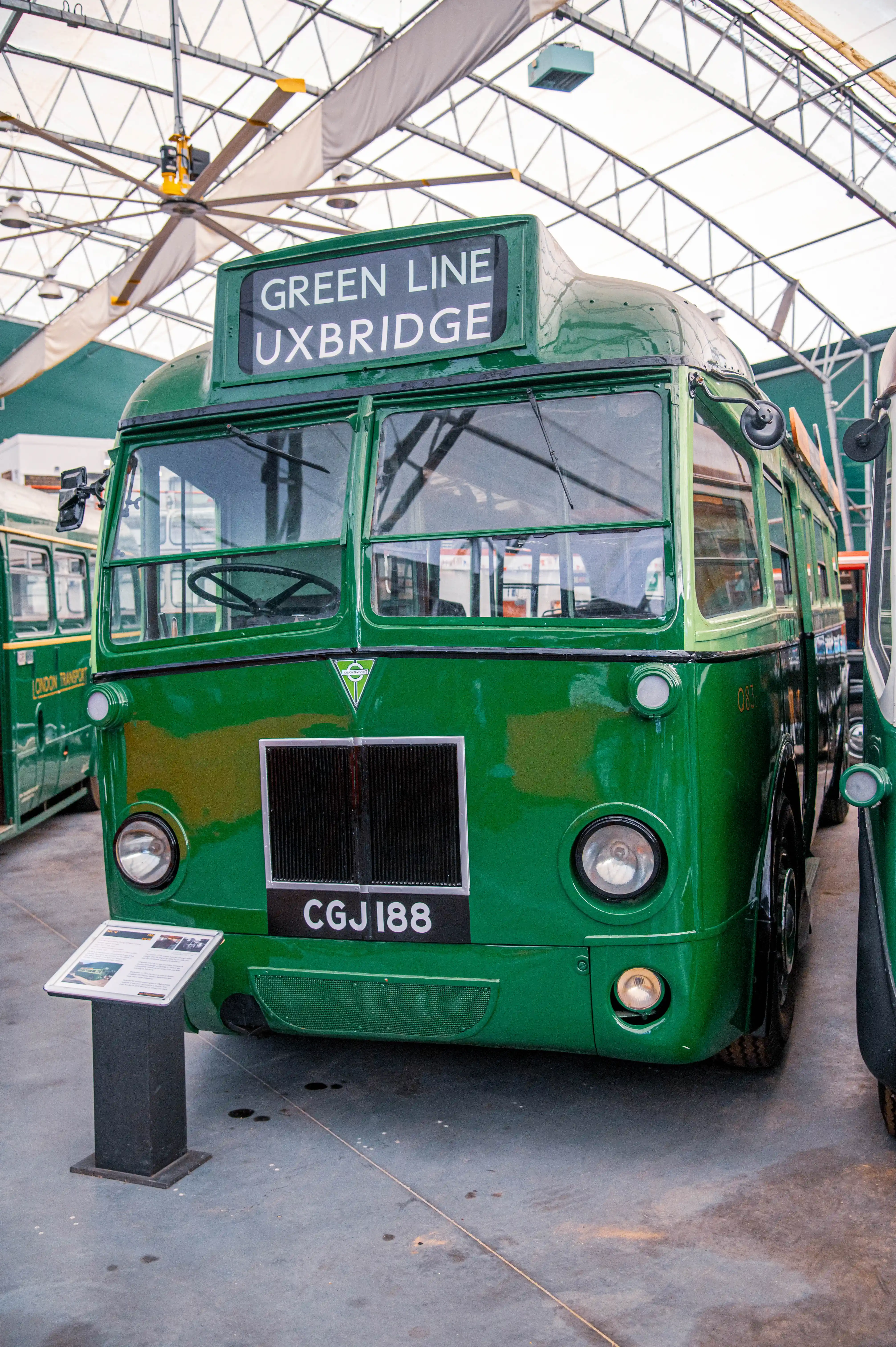 Front view of a gleaming green classic London bus with the destination board reading GREEN LINE UXBRIDGE.