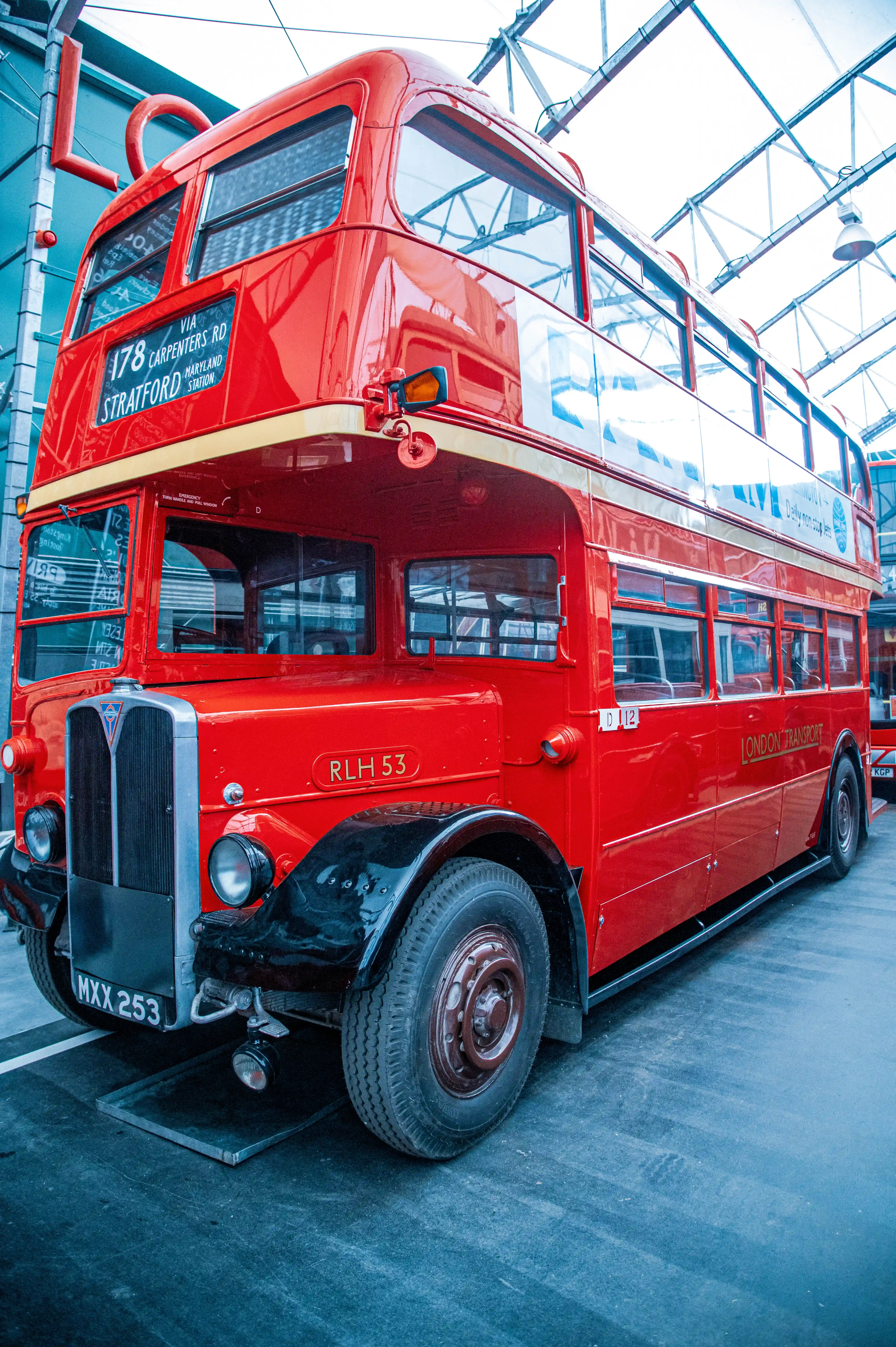 Front three-quarter view of a vintage red double-decker London bus with the route display showing '178 Via Carpenters Rd Stratford Station' and the registration plate 'MXX 253'.