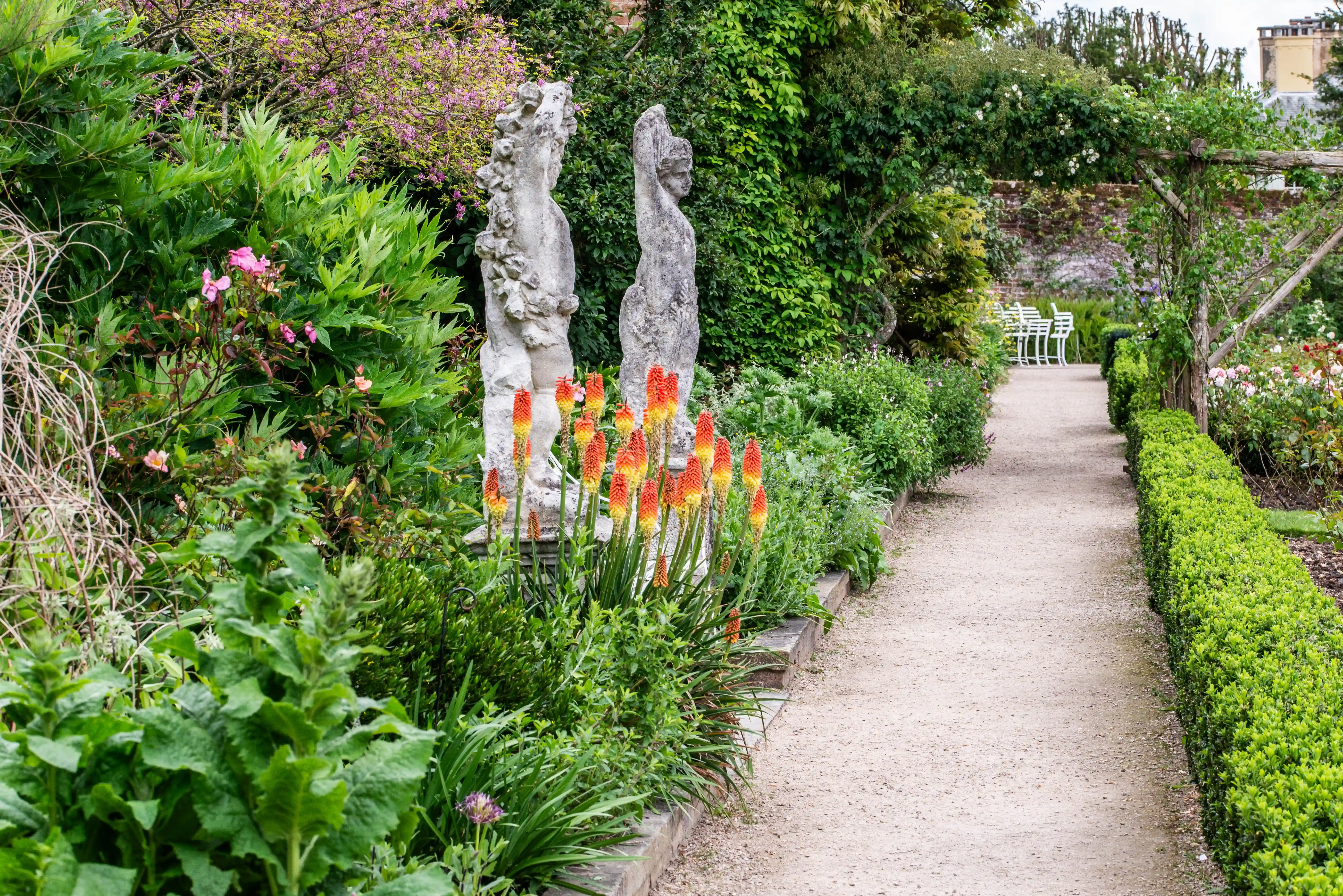 Edwardian Garden Path with Sculptures and Red Hot Pokers
