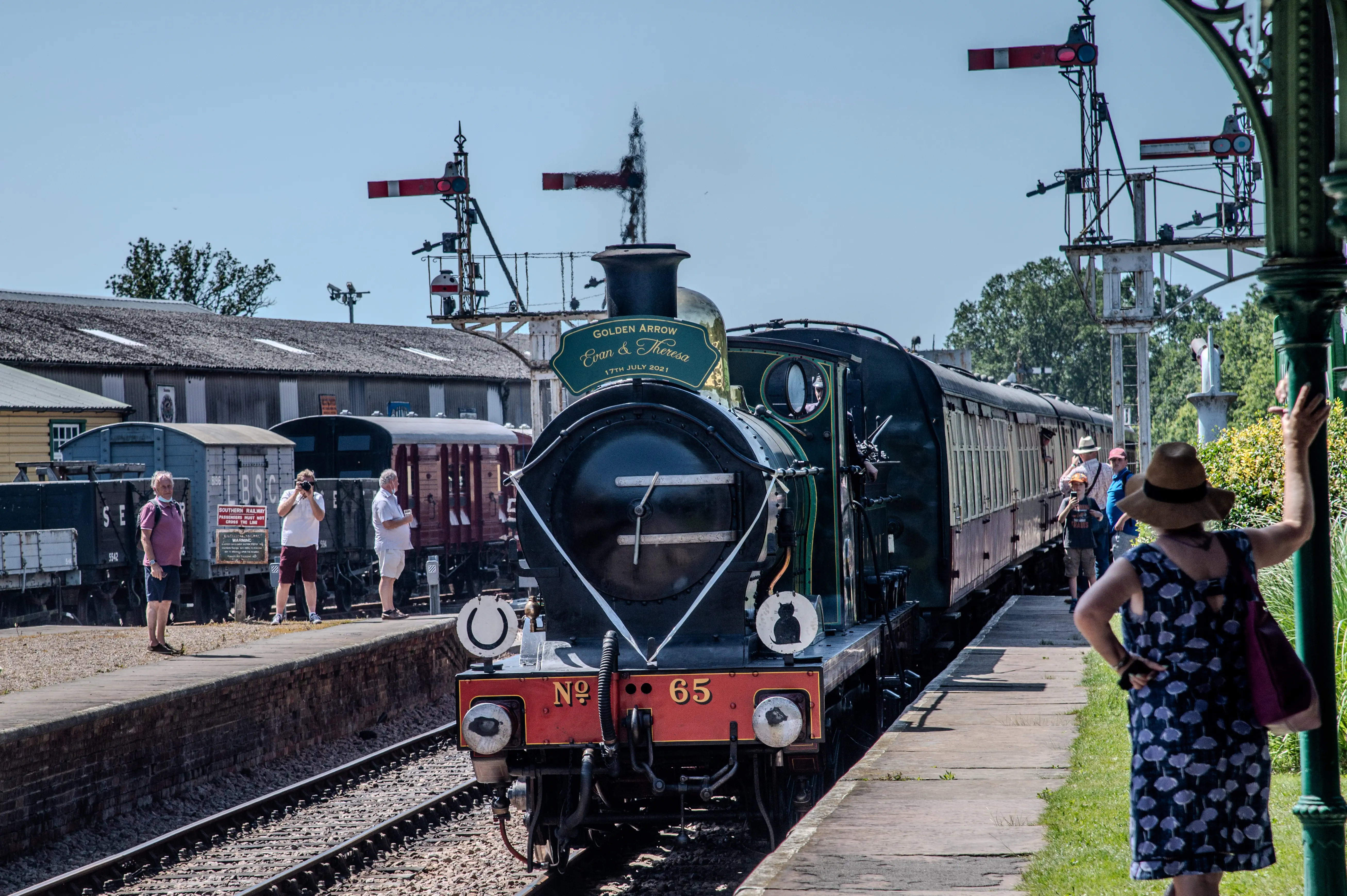 A green and black steam locomotive with a sign reading 