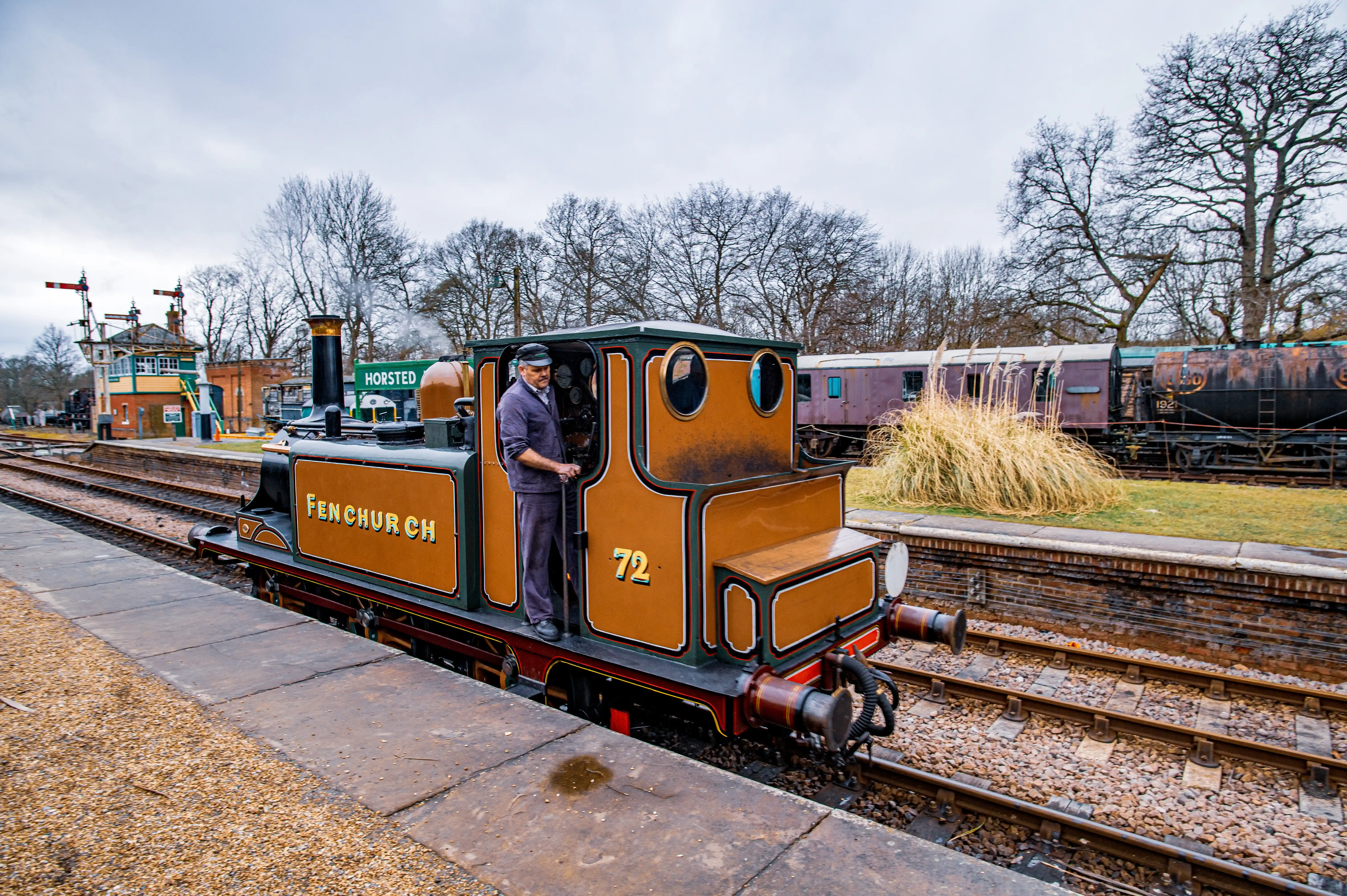A small, brown steam train labelled 