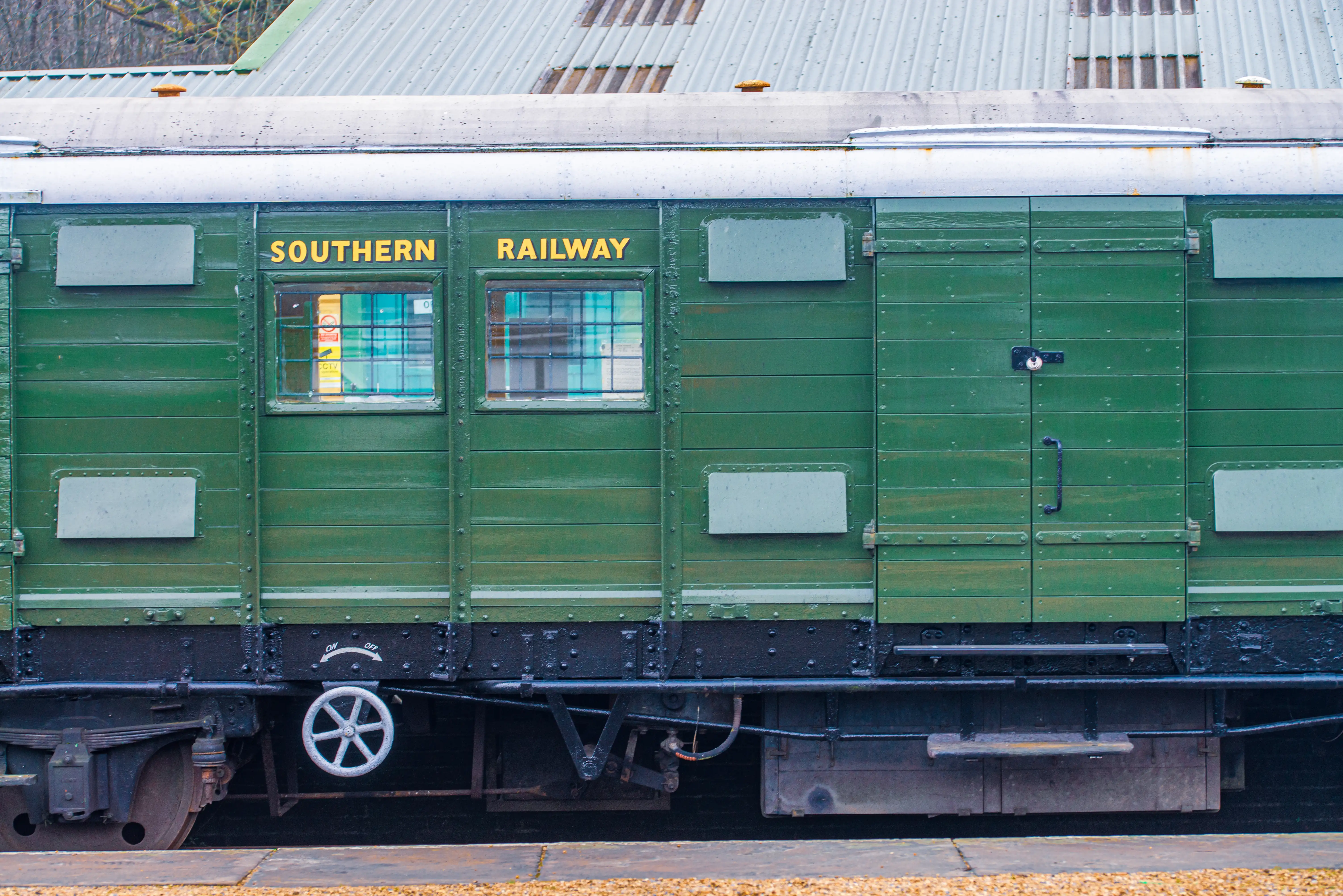 Side view of a green vintage train carriage with 'SOUTHERN RAILWAY' in yellow letters.