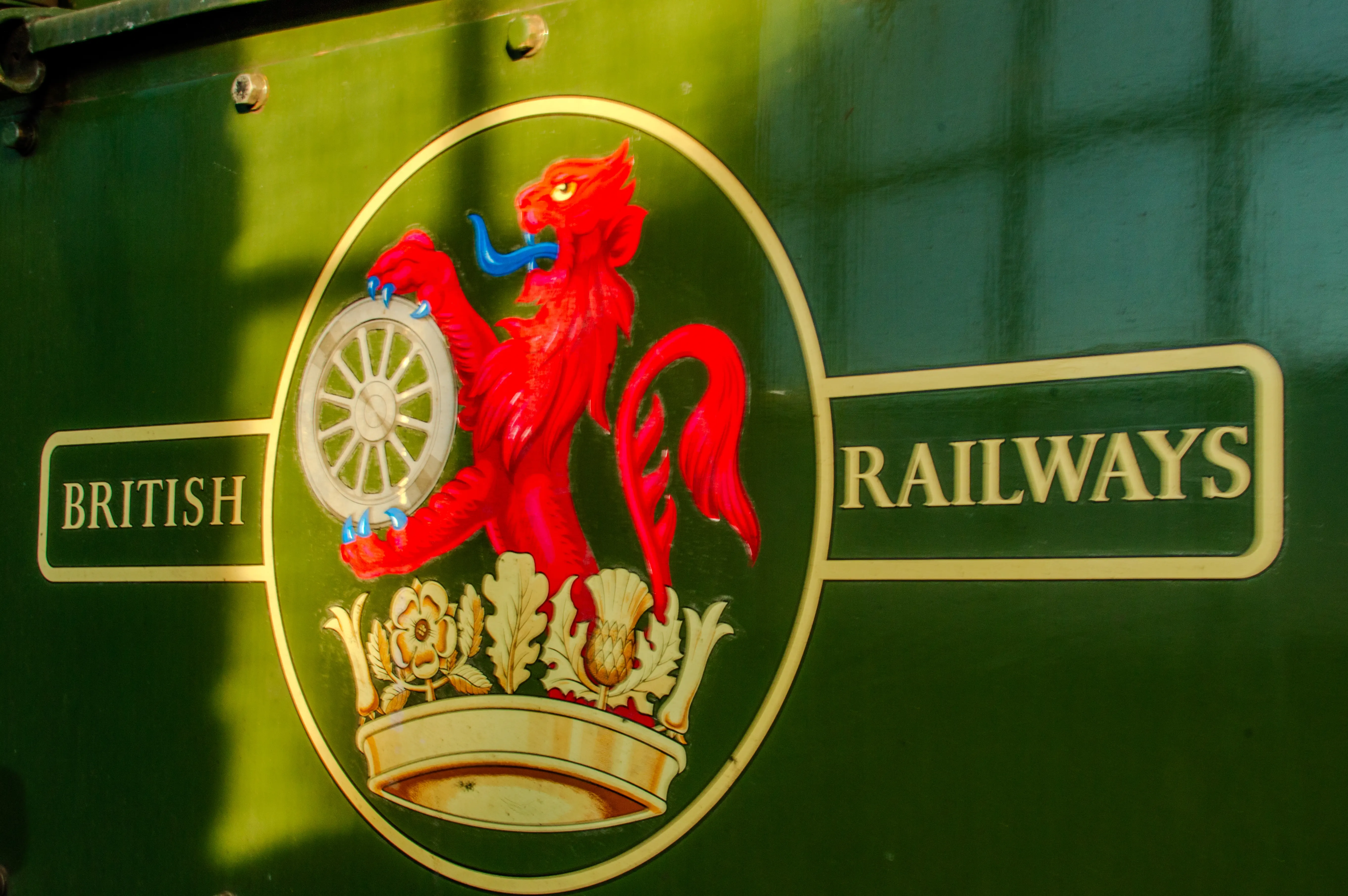 A close-up of the British Railways logo, showing a red lion rampant holding a wheel, with the words 'BRITISH' and 'RAILWAYS' on a green background.