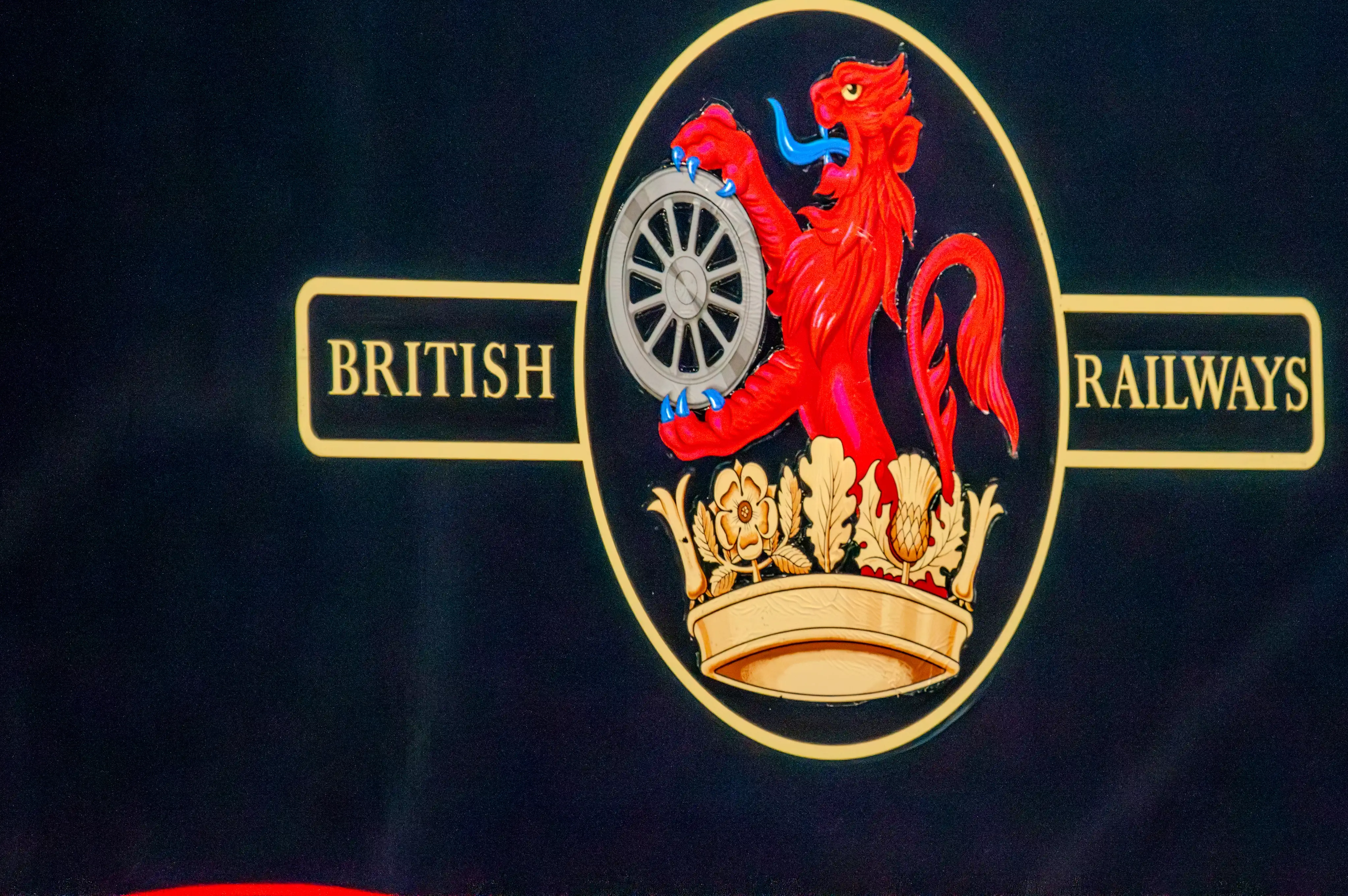 British Railways emblem showing a red lion holding a silver railway wheel above a gold crown with “British Railways” in gold lettering.