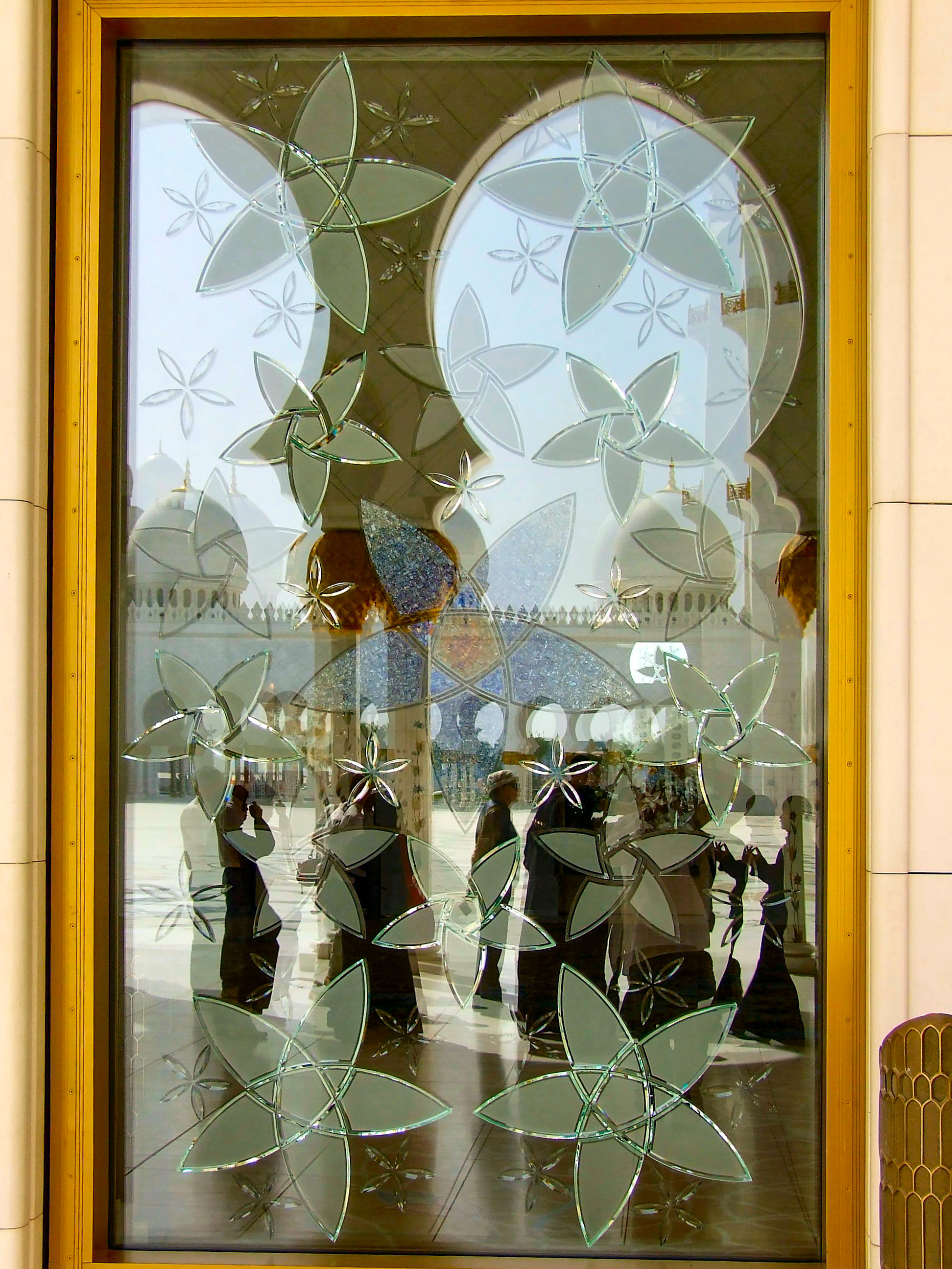 patterns on the window include geometric shapes and floral designs