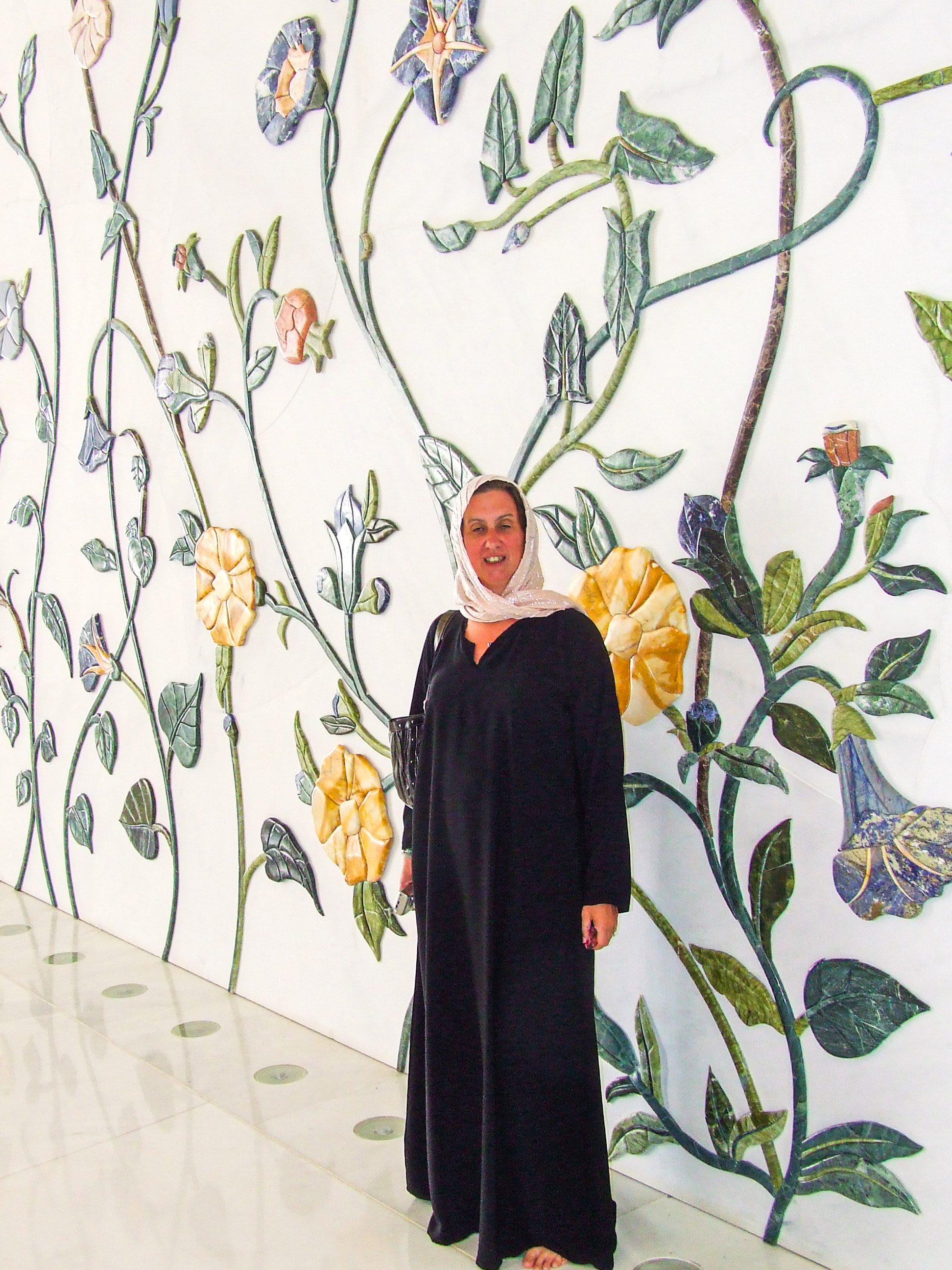 decorative wall featuring large, colorful flowers and leaves