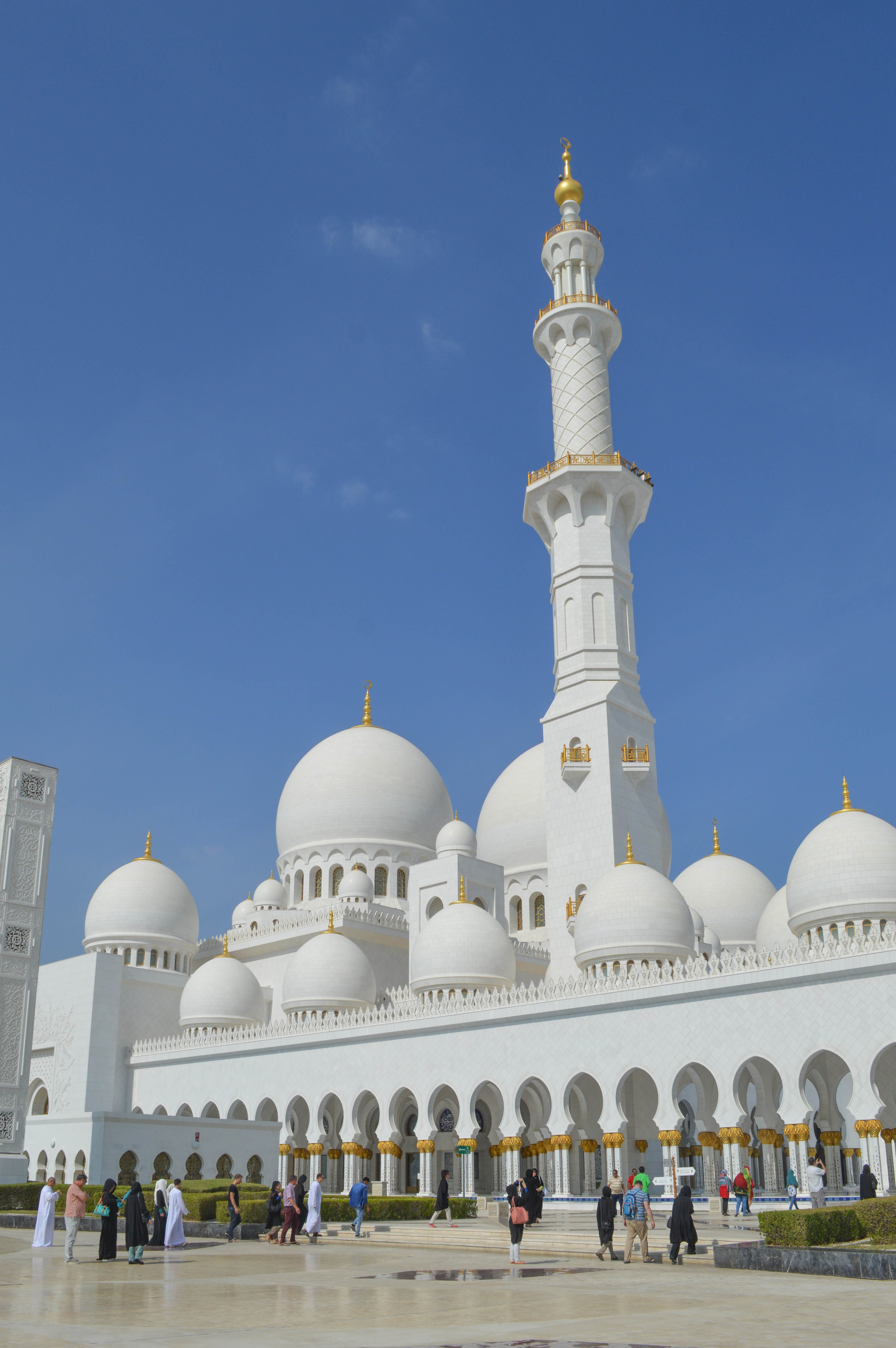 large white domes, tall minarets with gold accents